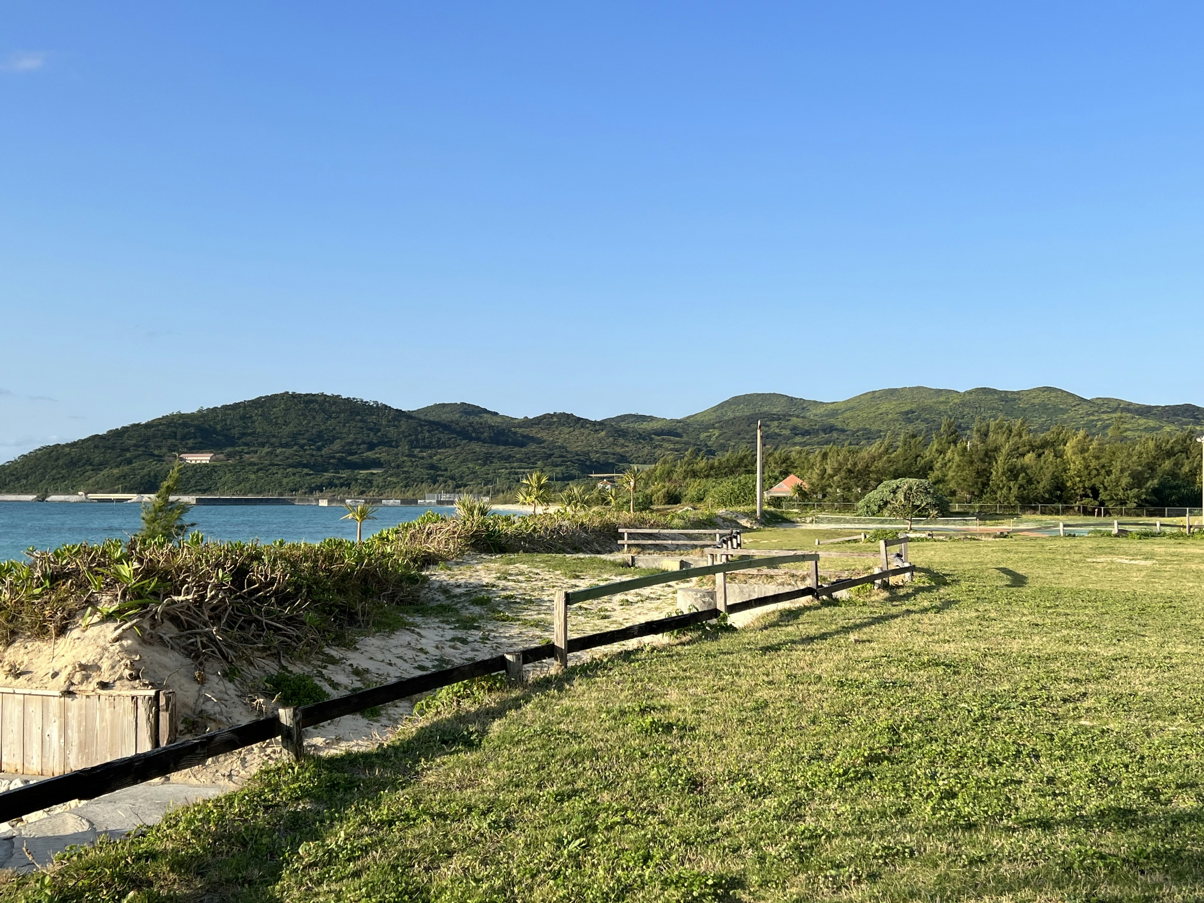 Coastal landscape with blue sky and green hills