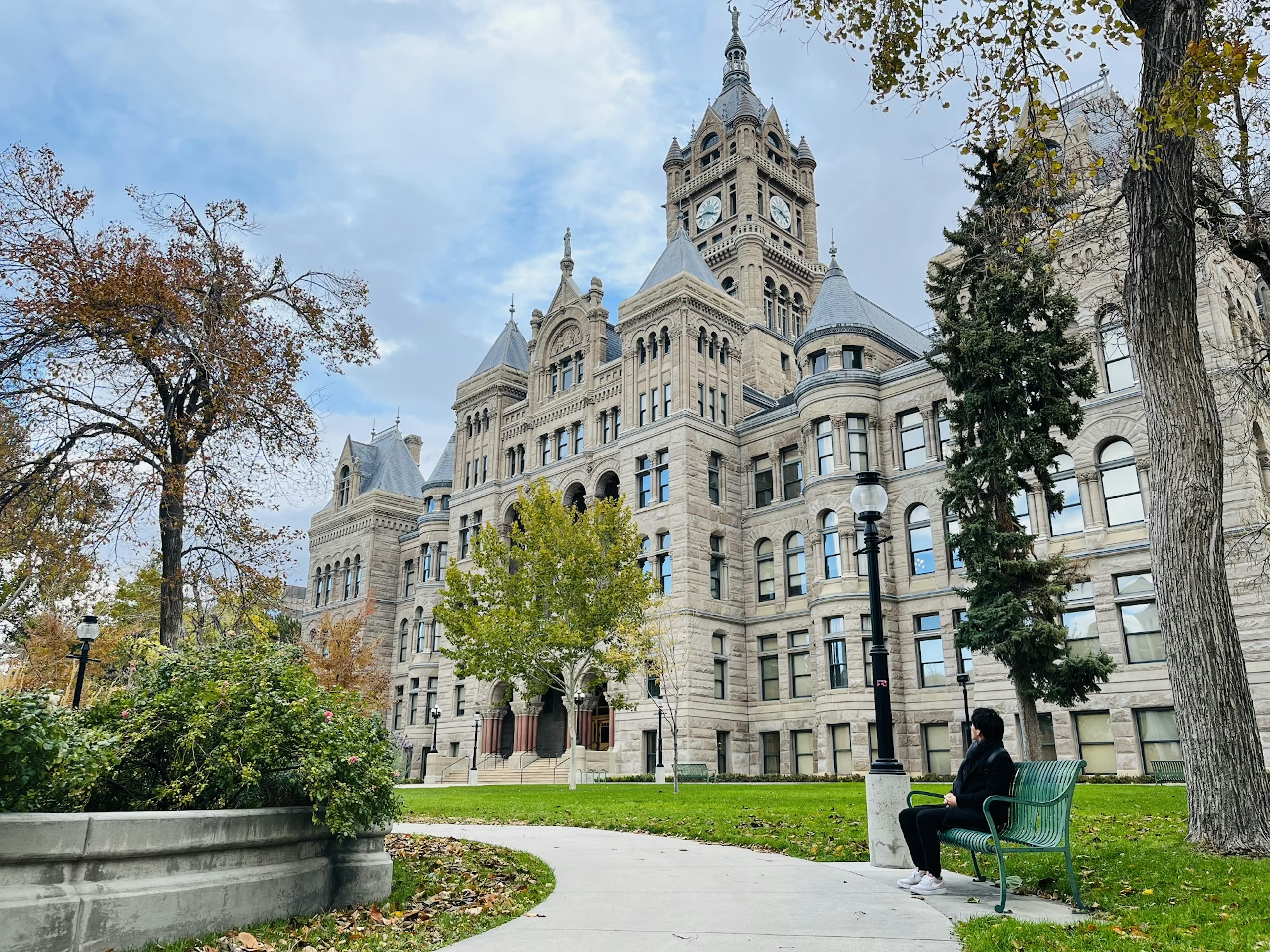 Historic building with clock tower surrounded by green park