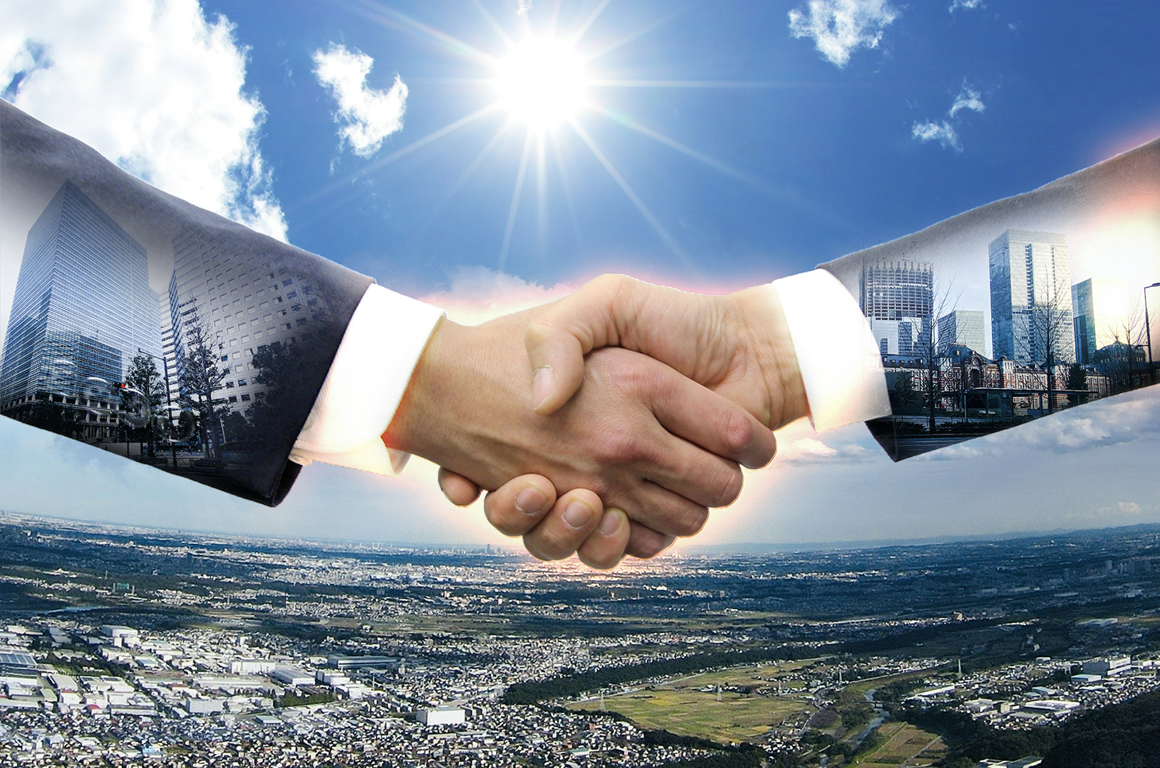 Businessmen shaking hands with a cityscape reflected in their hands