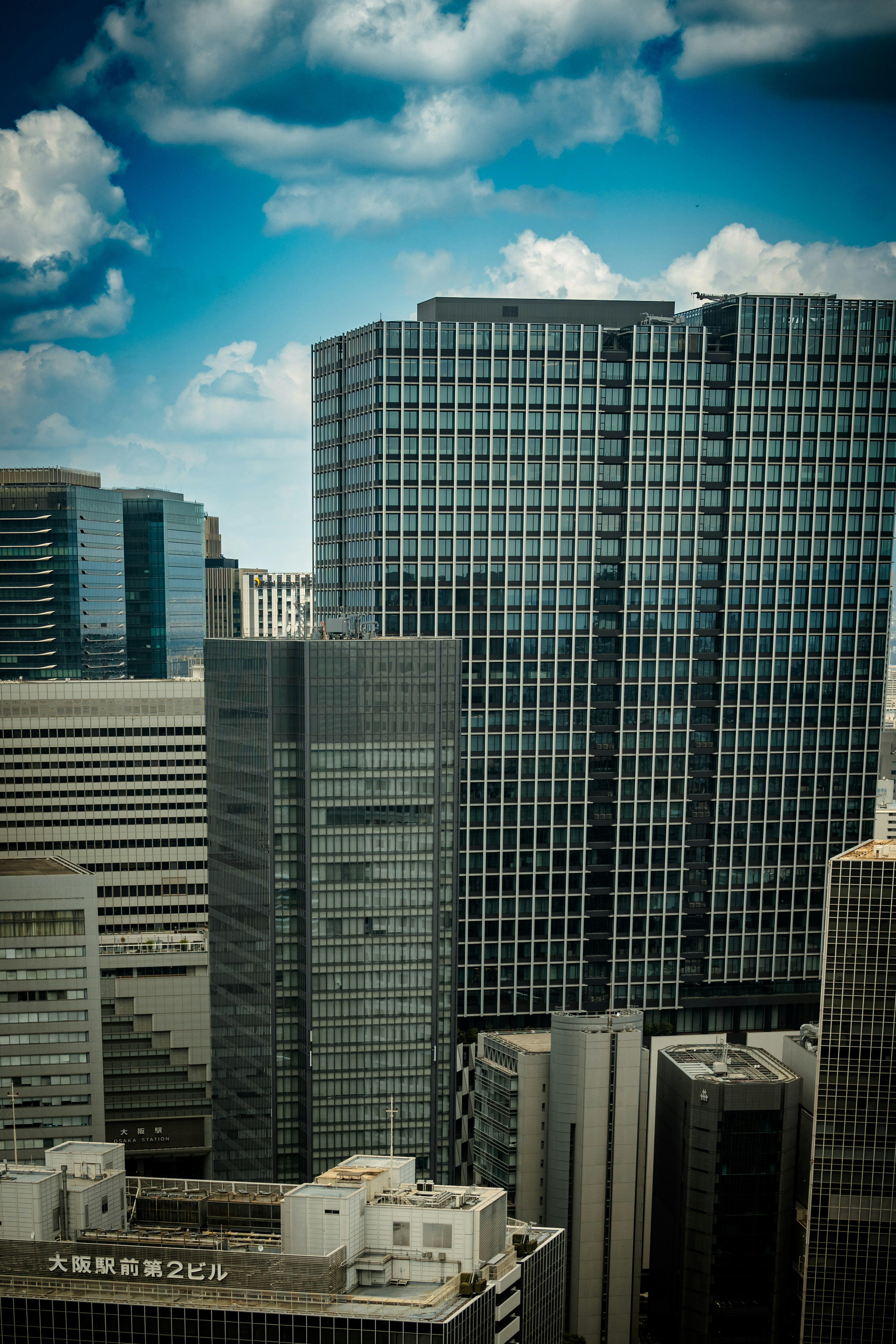 Cityscape featuring modern skyscrapers and a blue sky