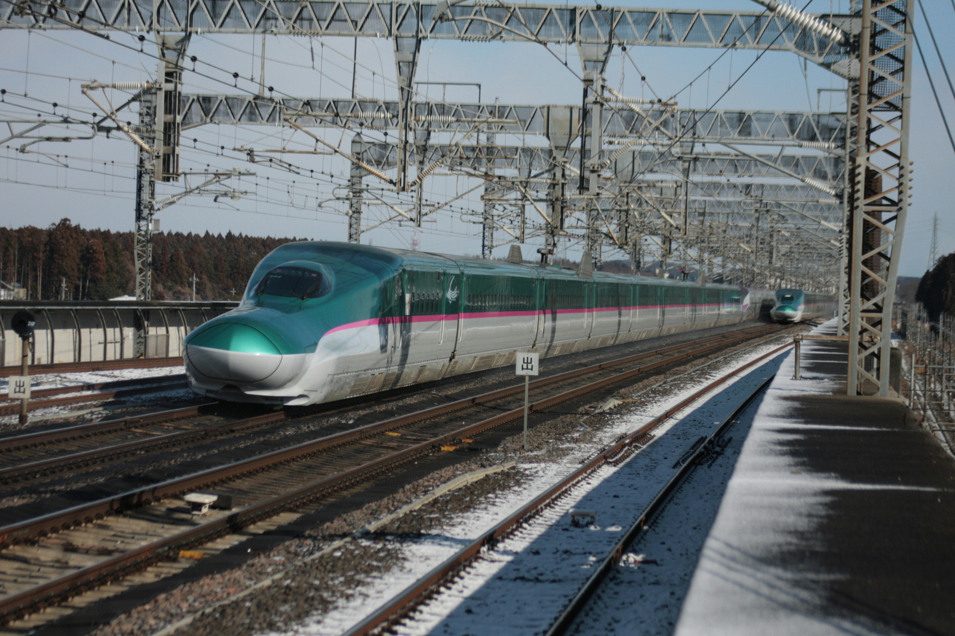 Shinkansen traveling on snowy tracks