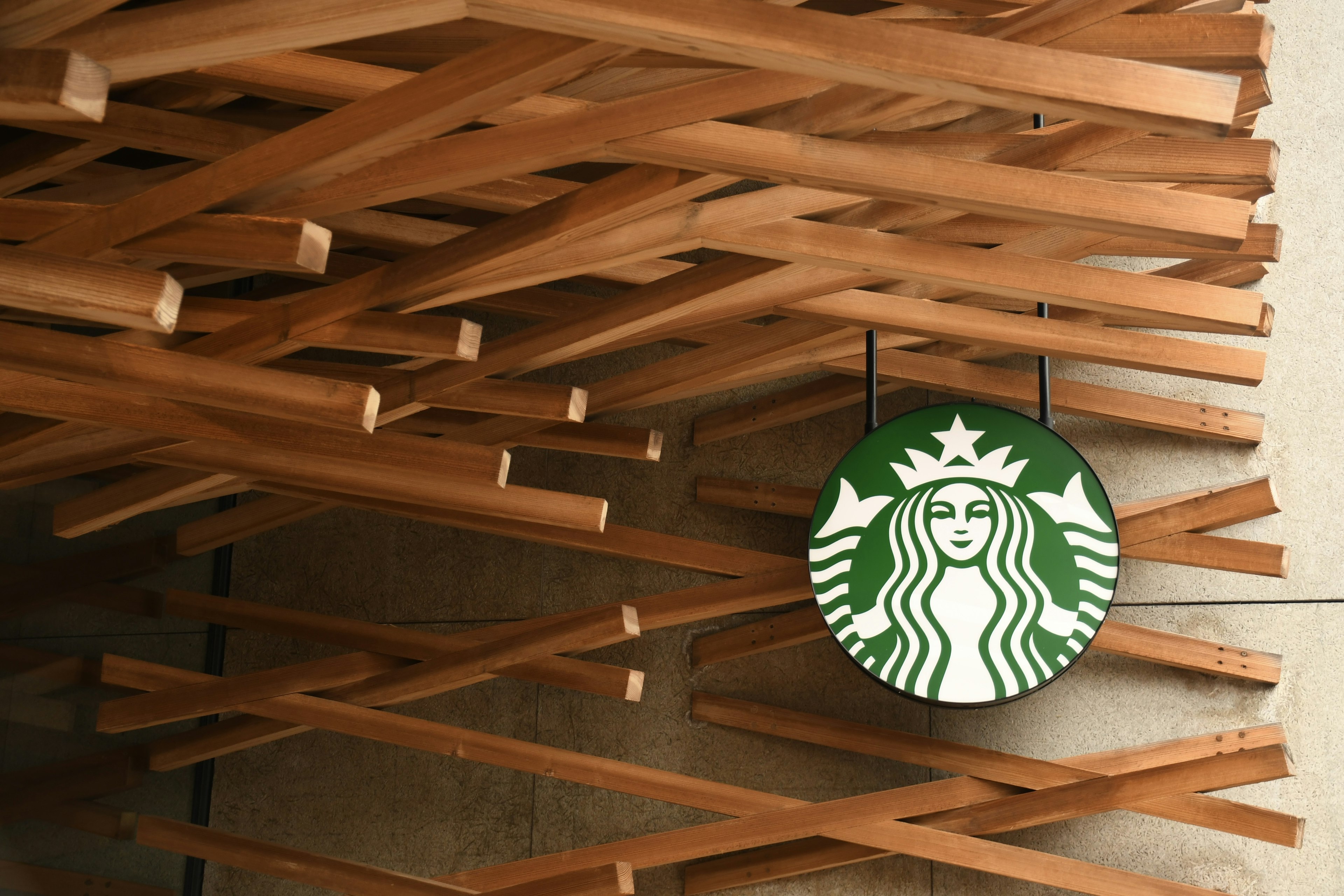 Starbucks logo against a backdrop of wooden decor