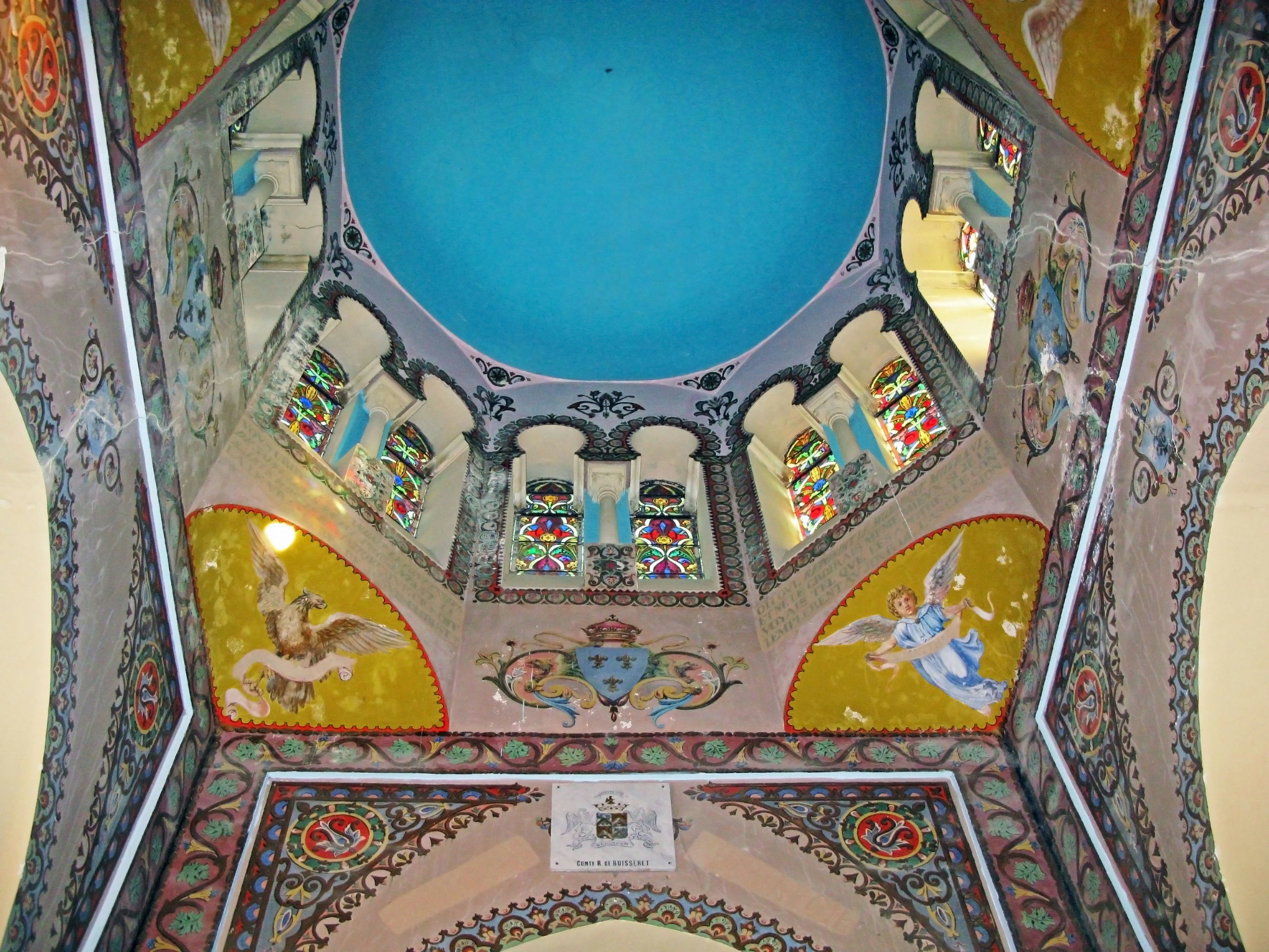 ornate ceiling with vibrant colors and a central blue dome