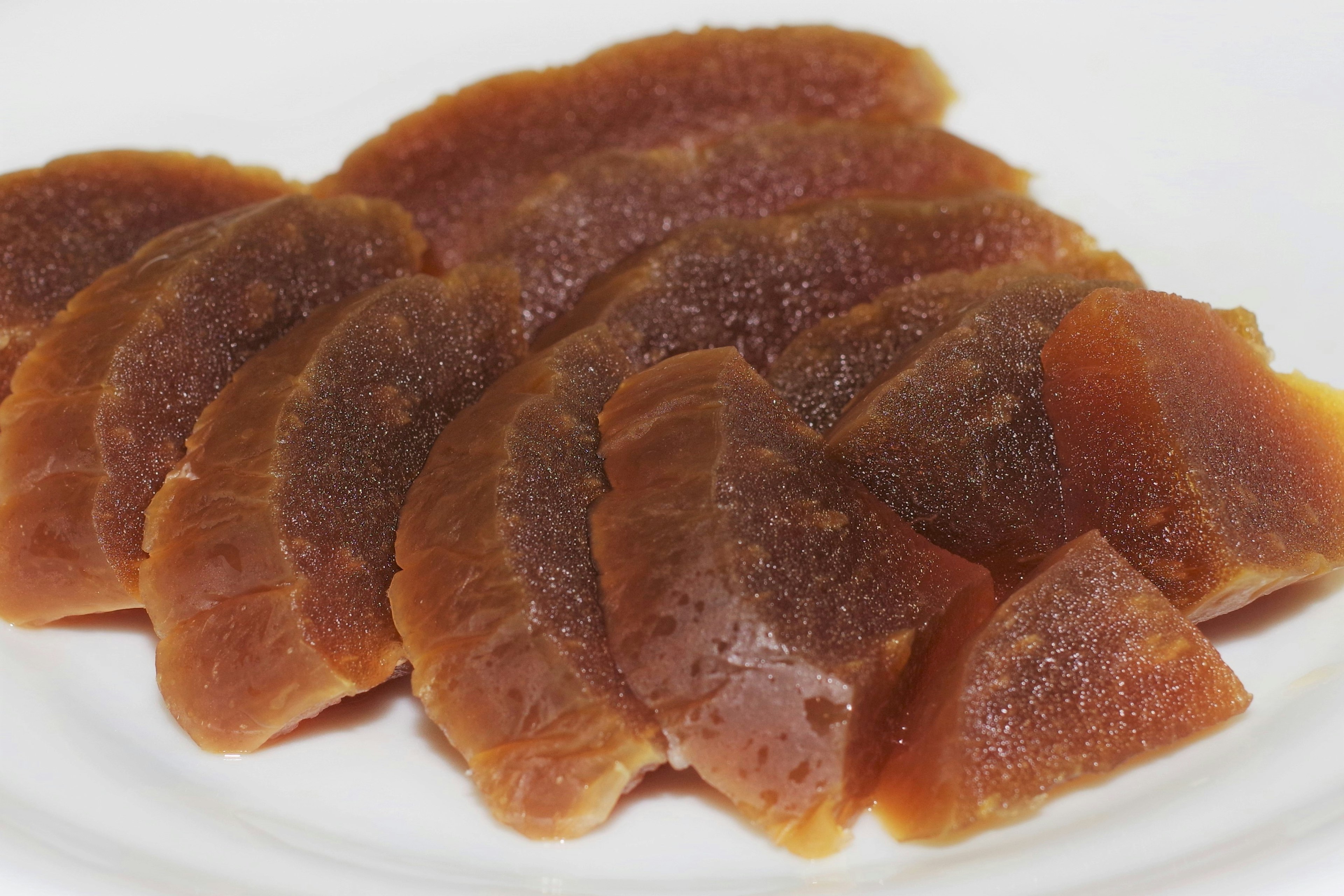 Sliced sweet fruit jelly arranged on a white plate