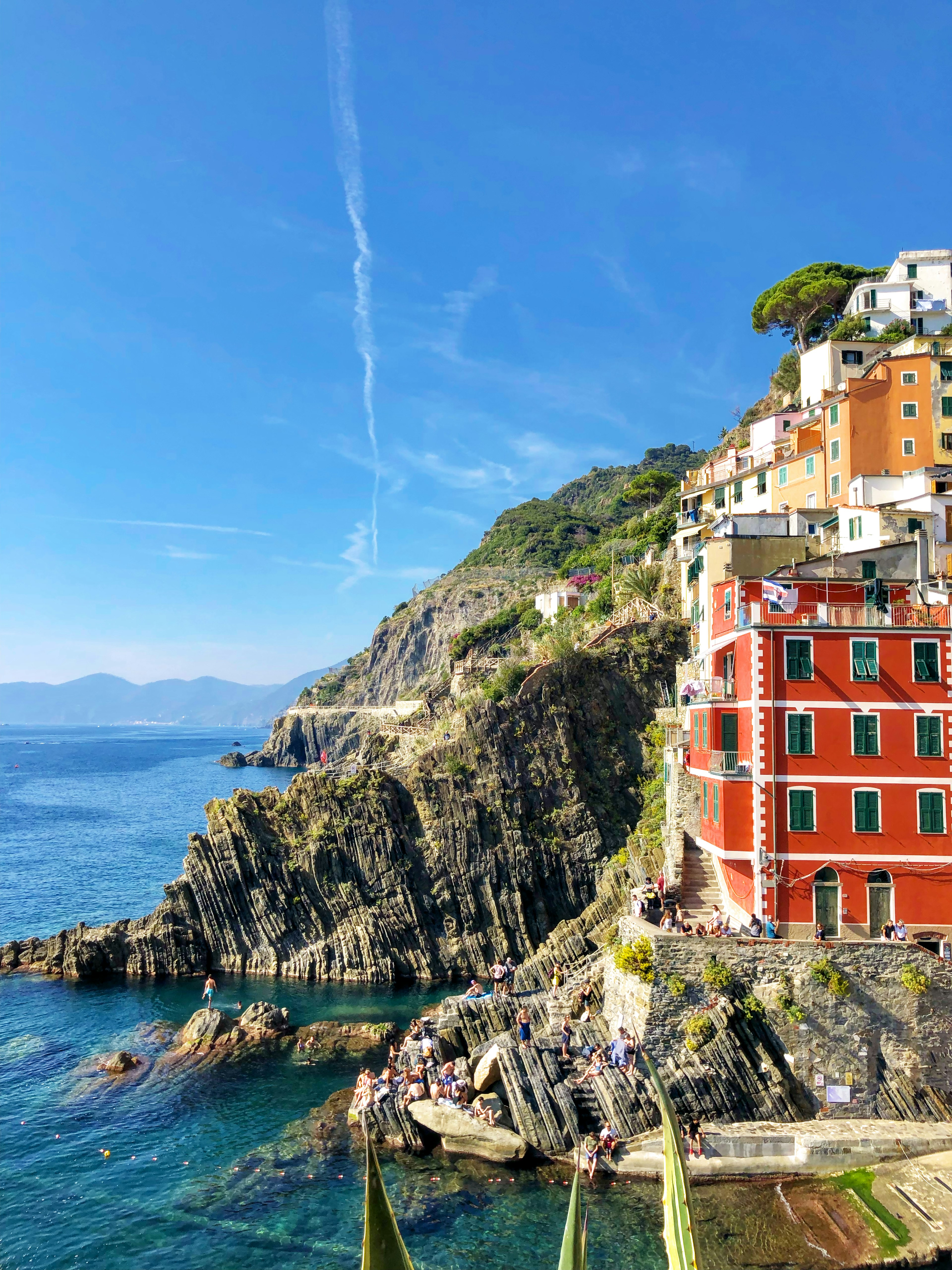 Colorful buildings along a beautiful coastline with a clear blue sky