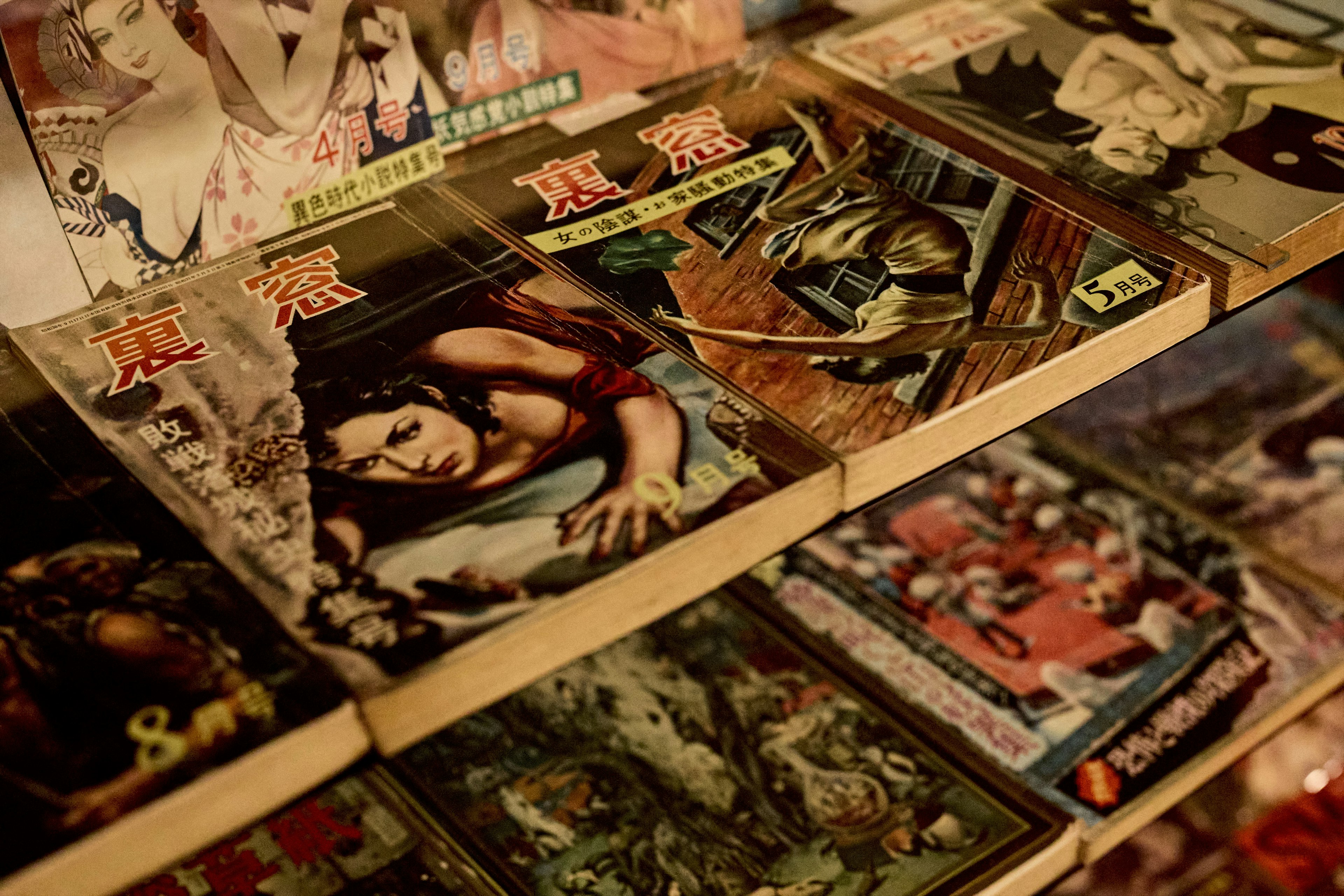 Close-up of vintage comic book covers displayed on a shelf