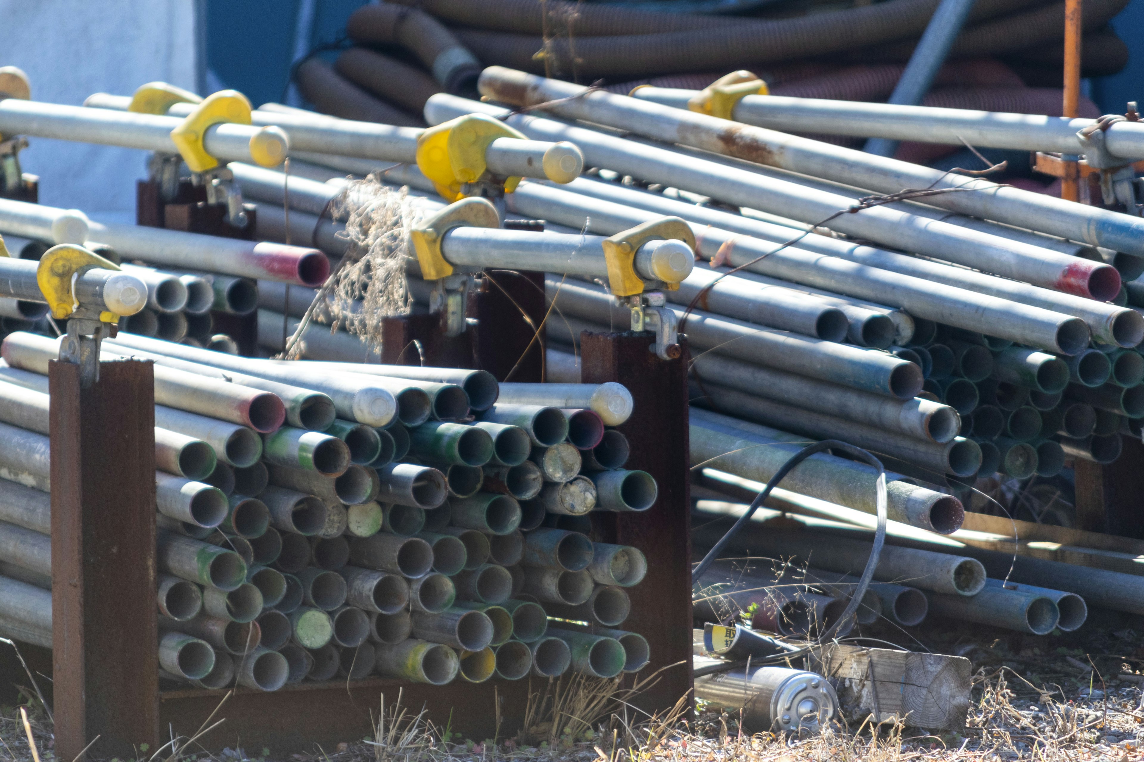 Stacked metal pipes at a construction site