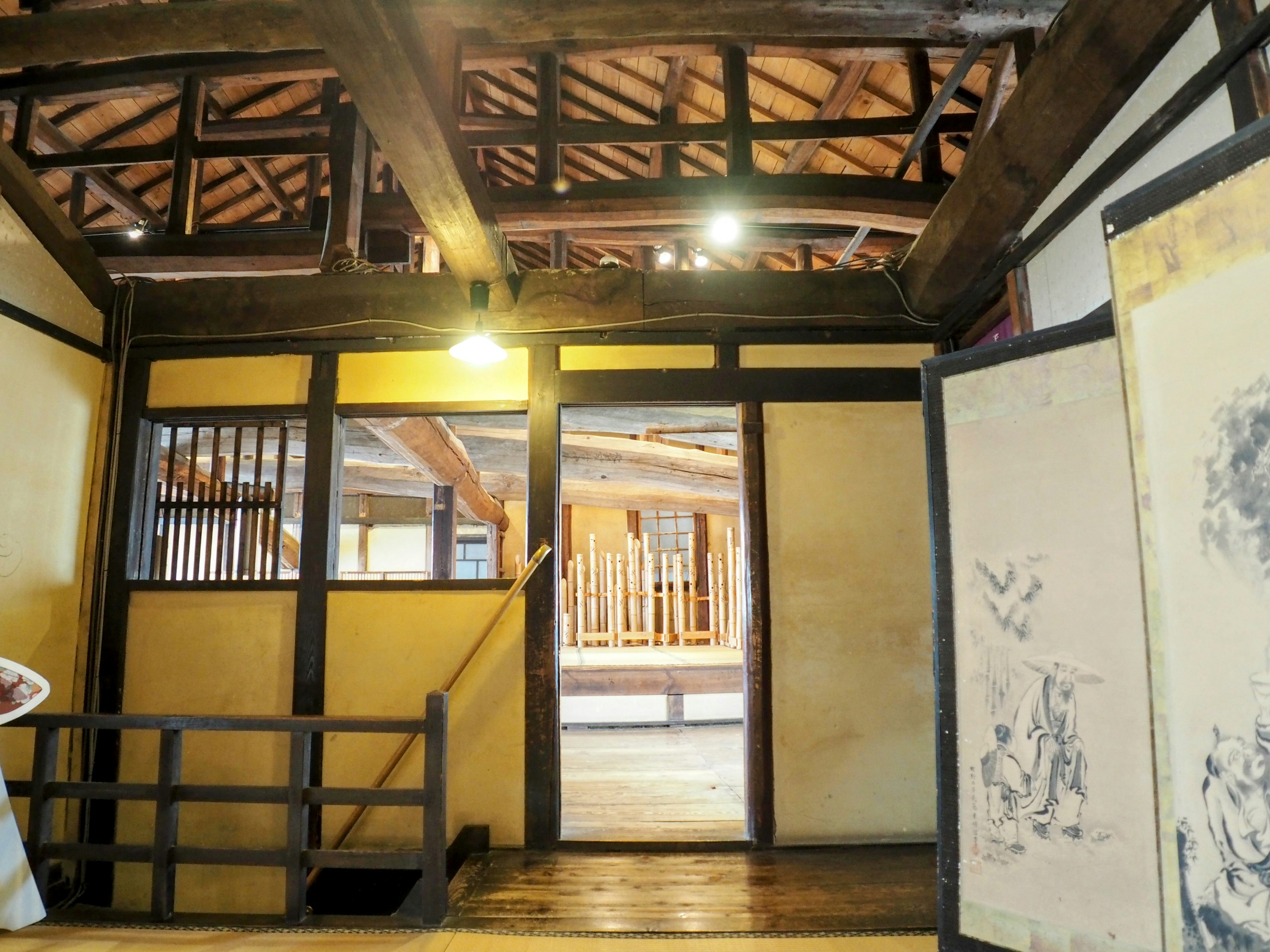 Interior of a traditional Japanese house featuring wooden beams and shoji screens