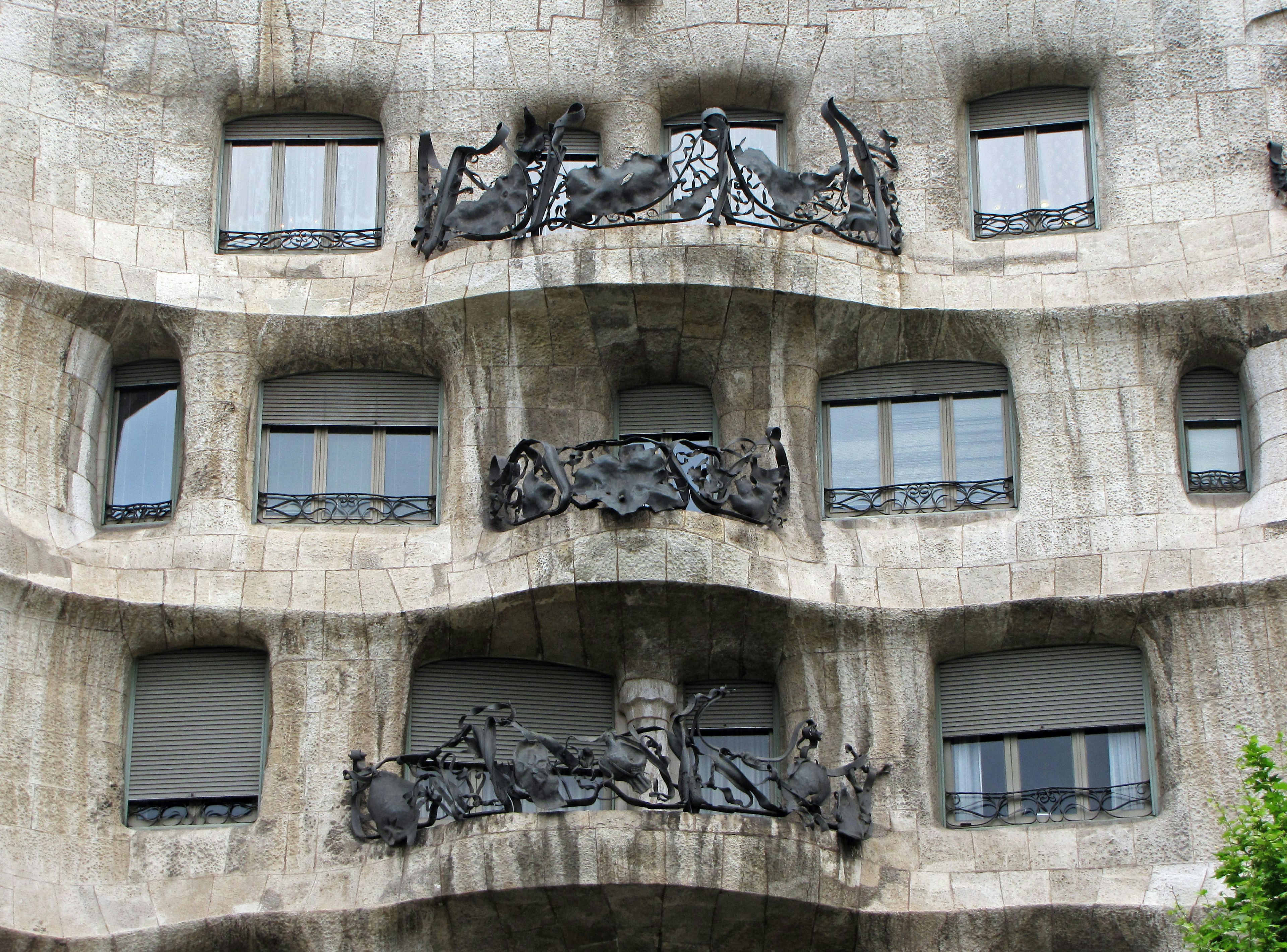 Facade of Casa Milà featuring sculptures and unique balconies