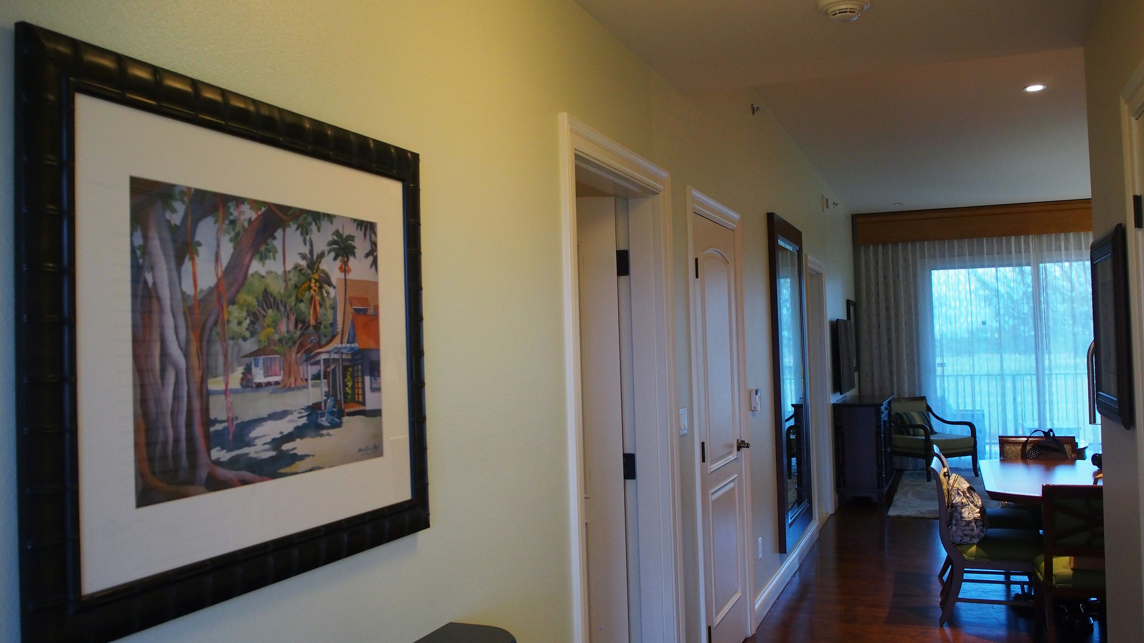 Hallway with framed painting on the wall and bright interior