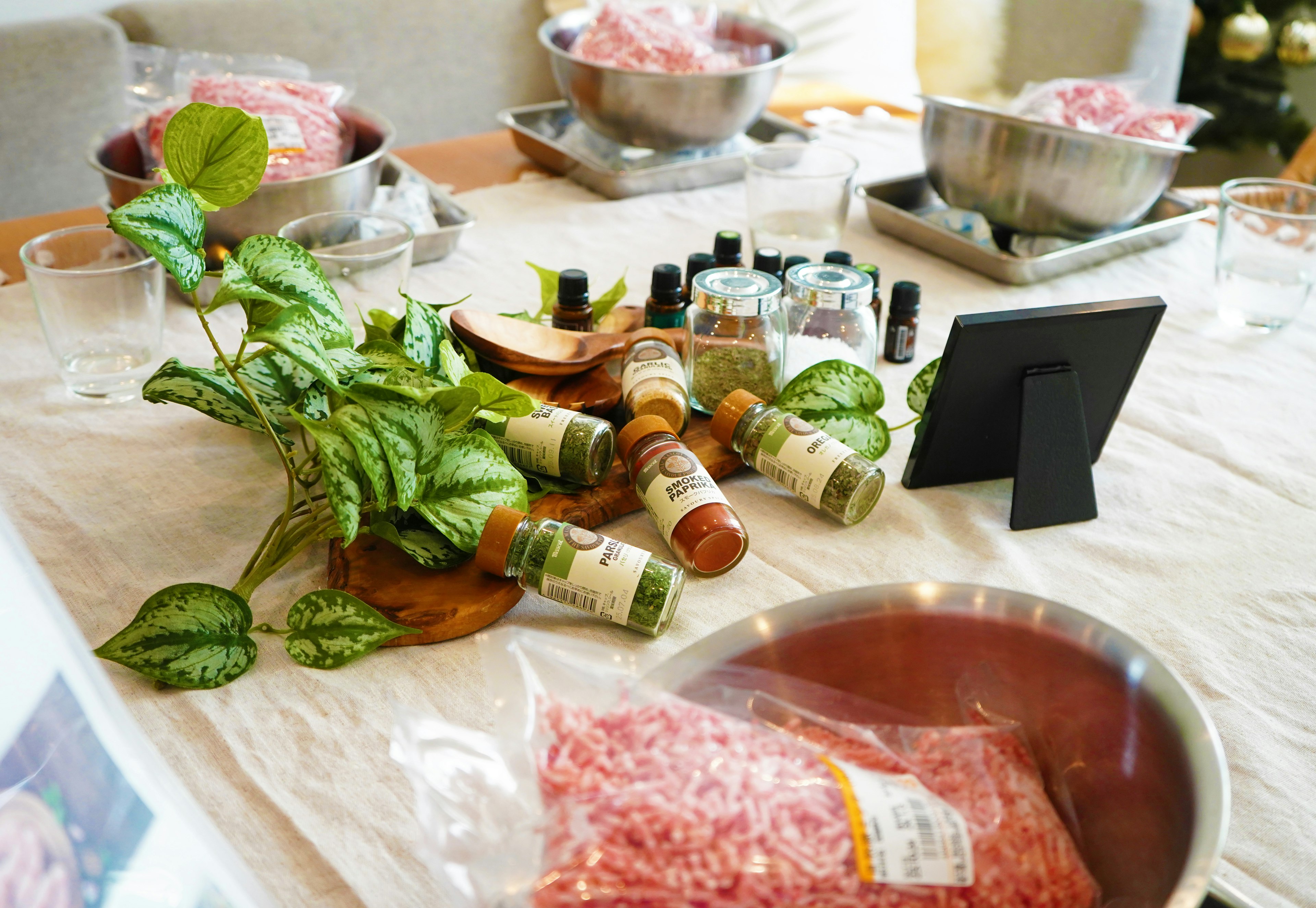 Preparation scene with bowls of ingredients and spice bottles on a table