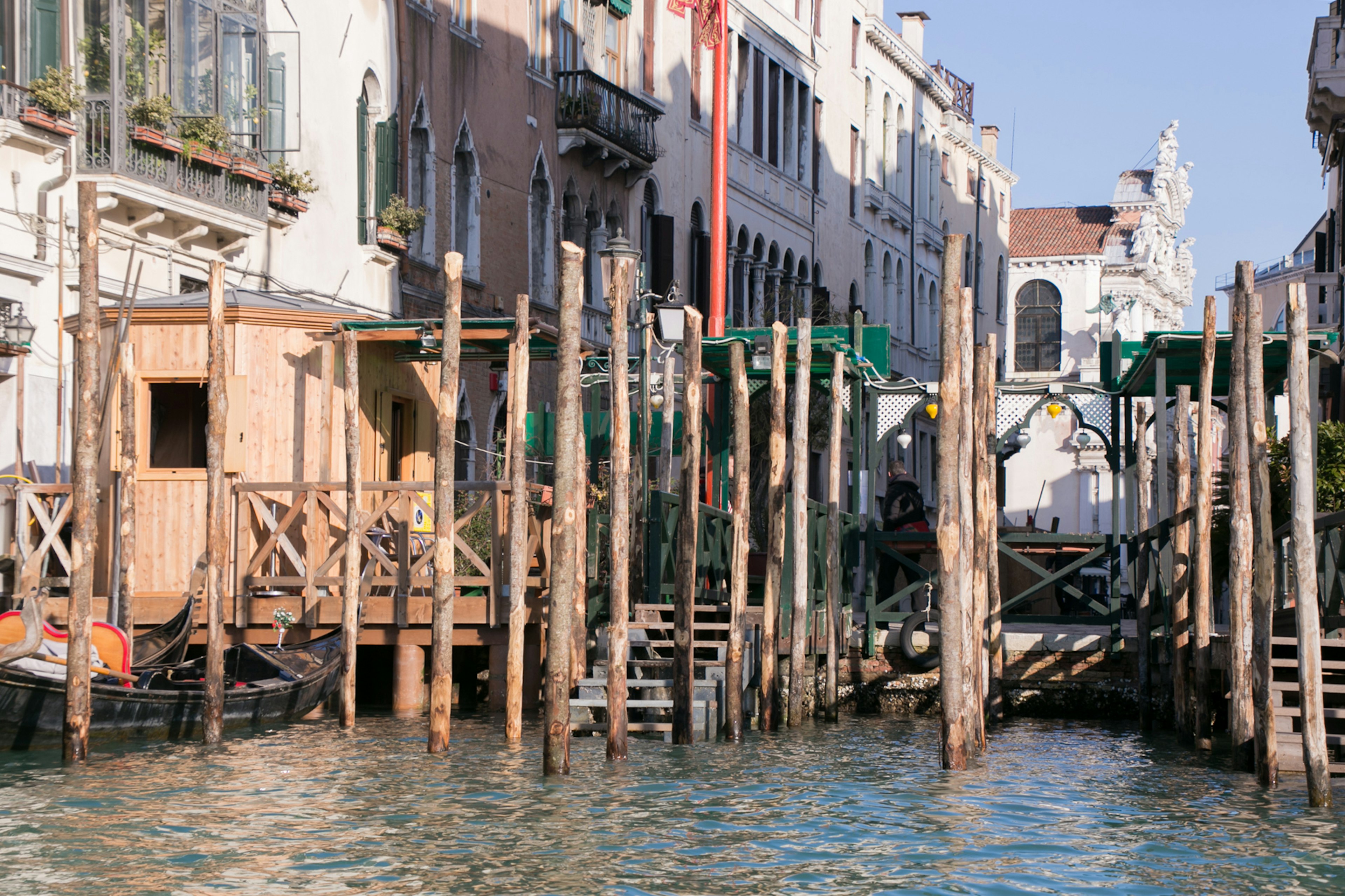 Wooden dock and old buildings along a canal in Venice