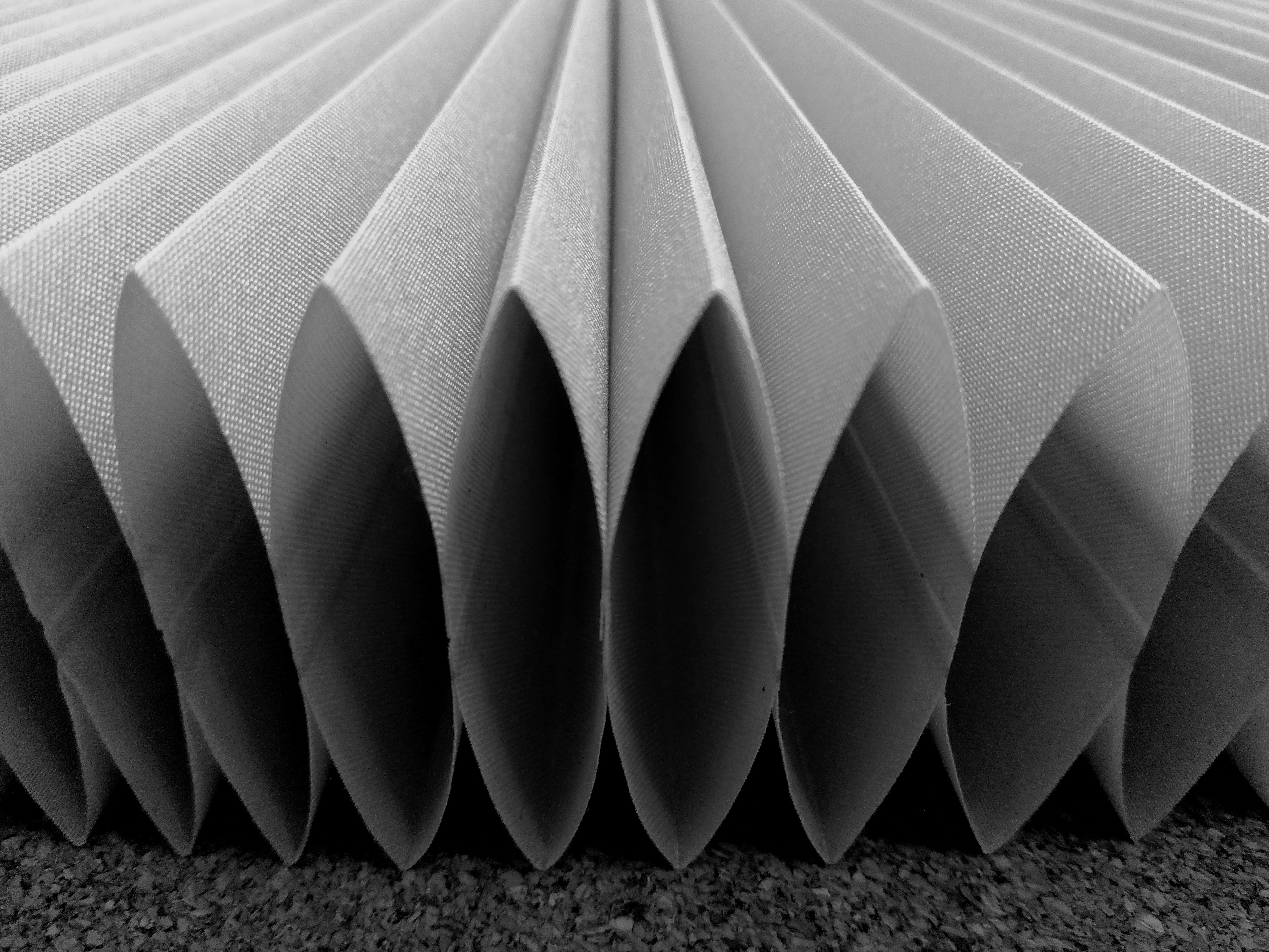 Image of folded gray paper layers arranged in a pattern