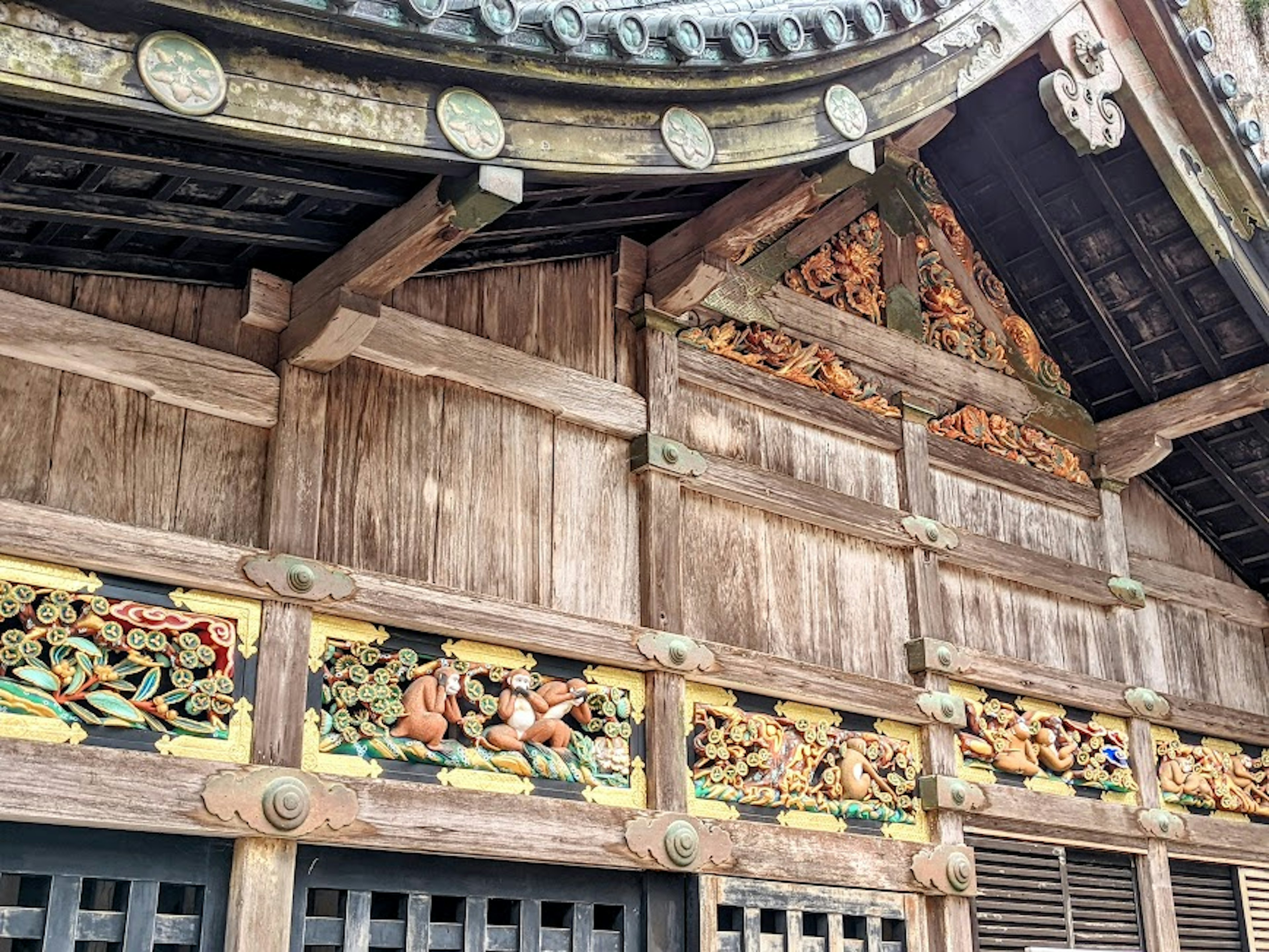 Wooden wall of traditional Japanese architecture adorned with colorful carvings