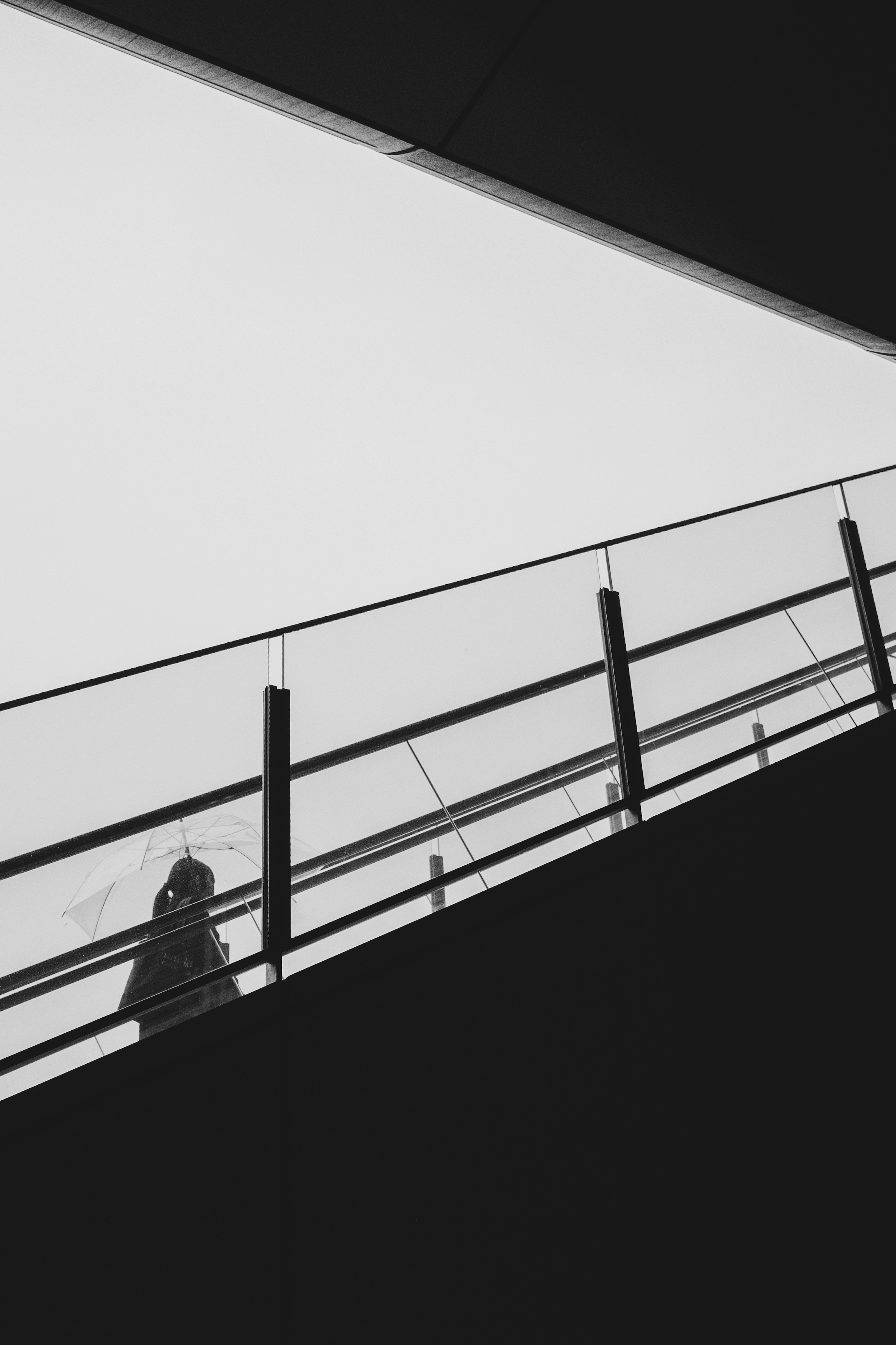 Silhouette of a person walking up stairs with modern architectural lines