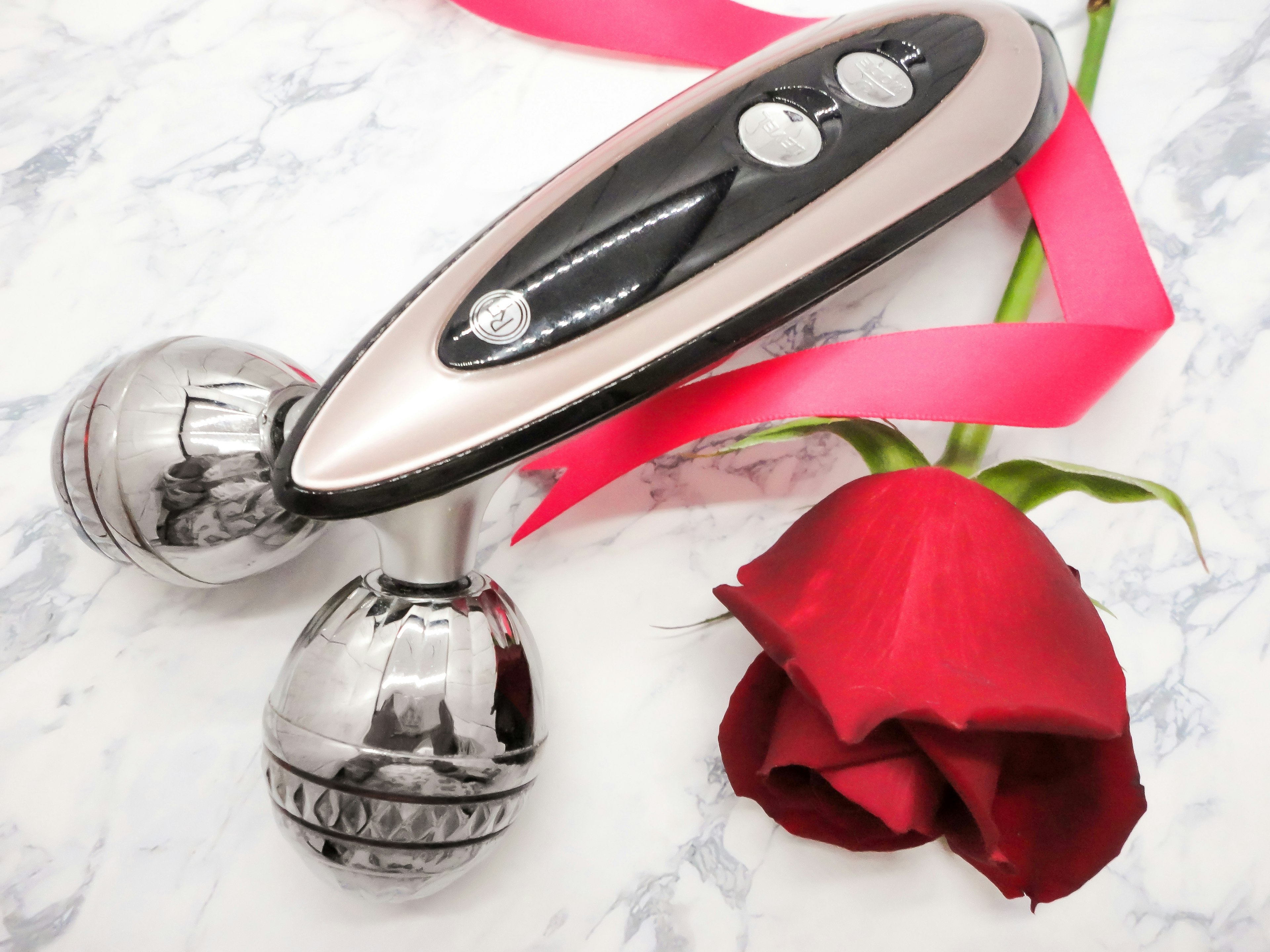 Beauty device with a rose and pink ribbon