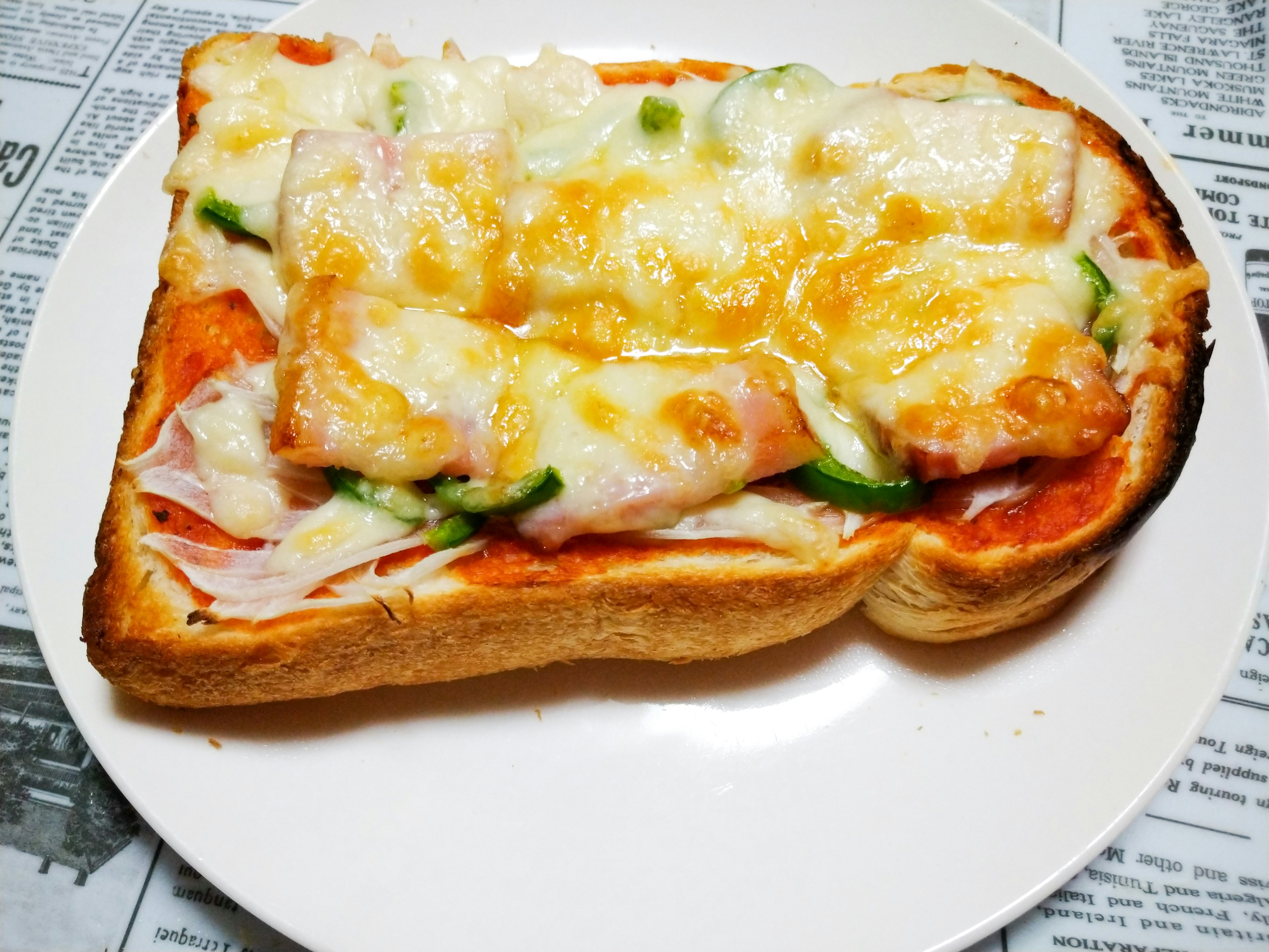 Toast topped with cheese ham and vegetables