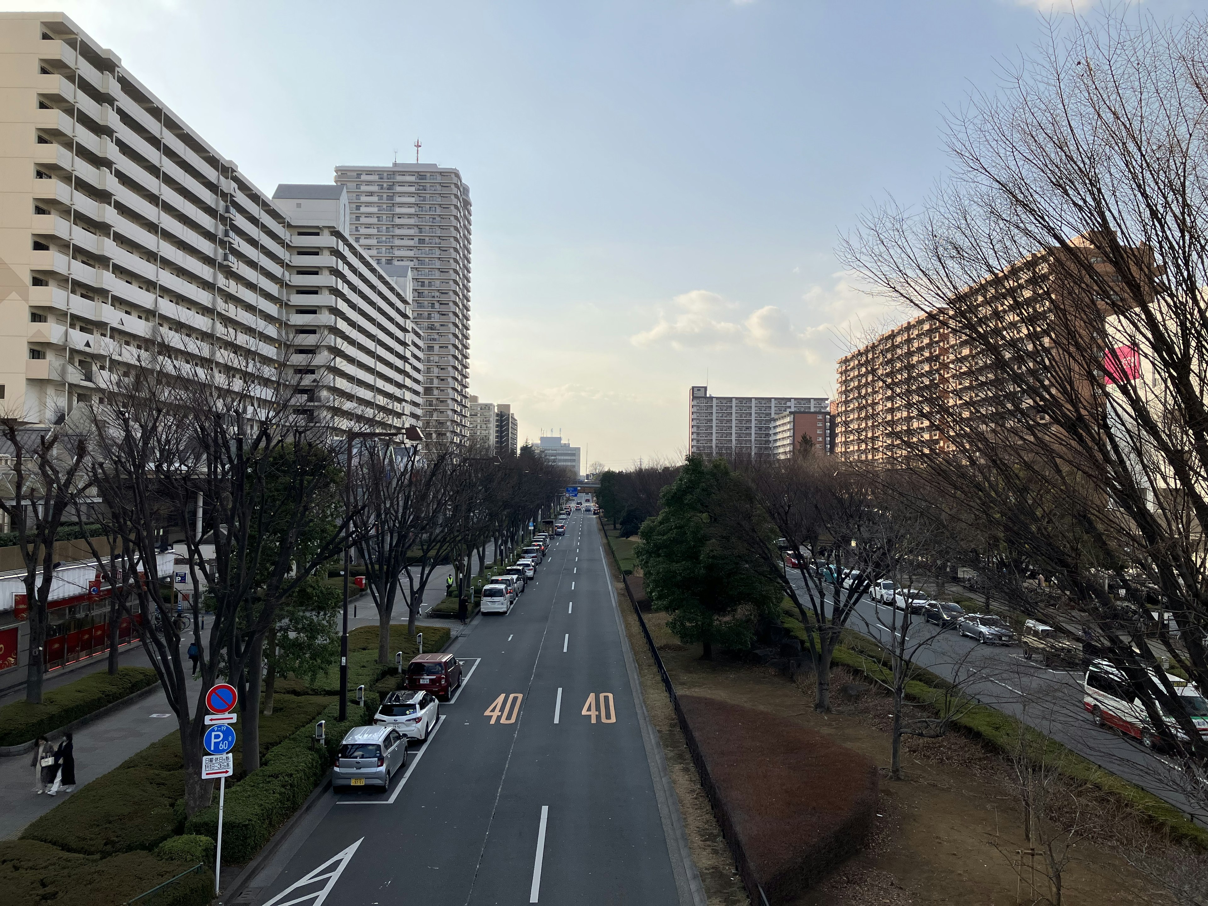 Wide street lined with tall buildings in an urban setting