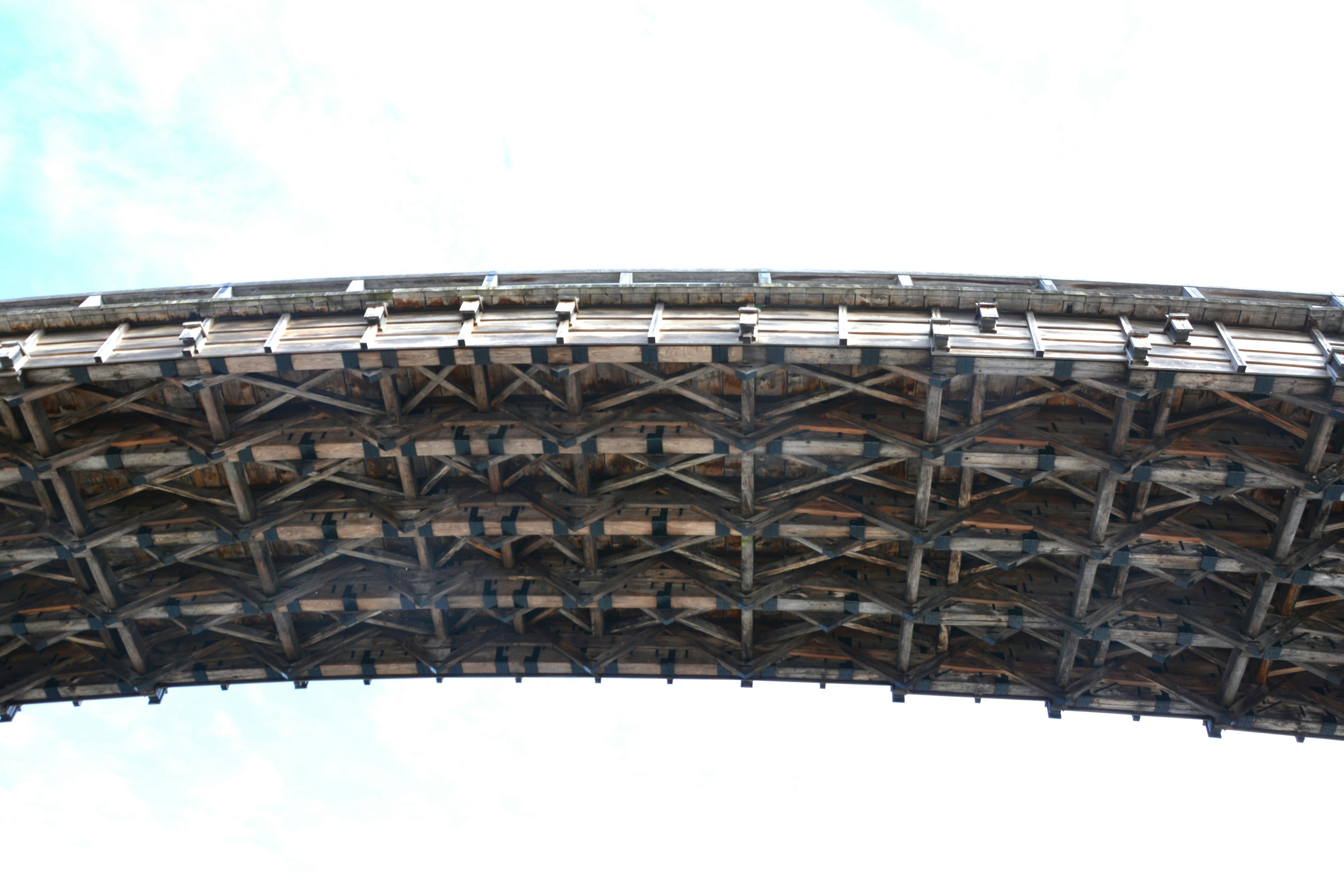 Detailed view of a wooden arch bridge from underneath