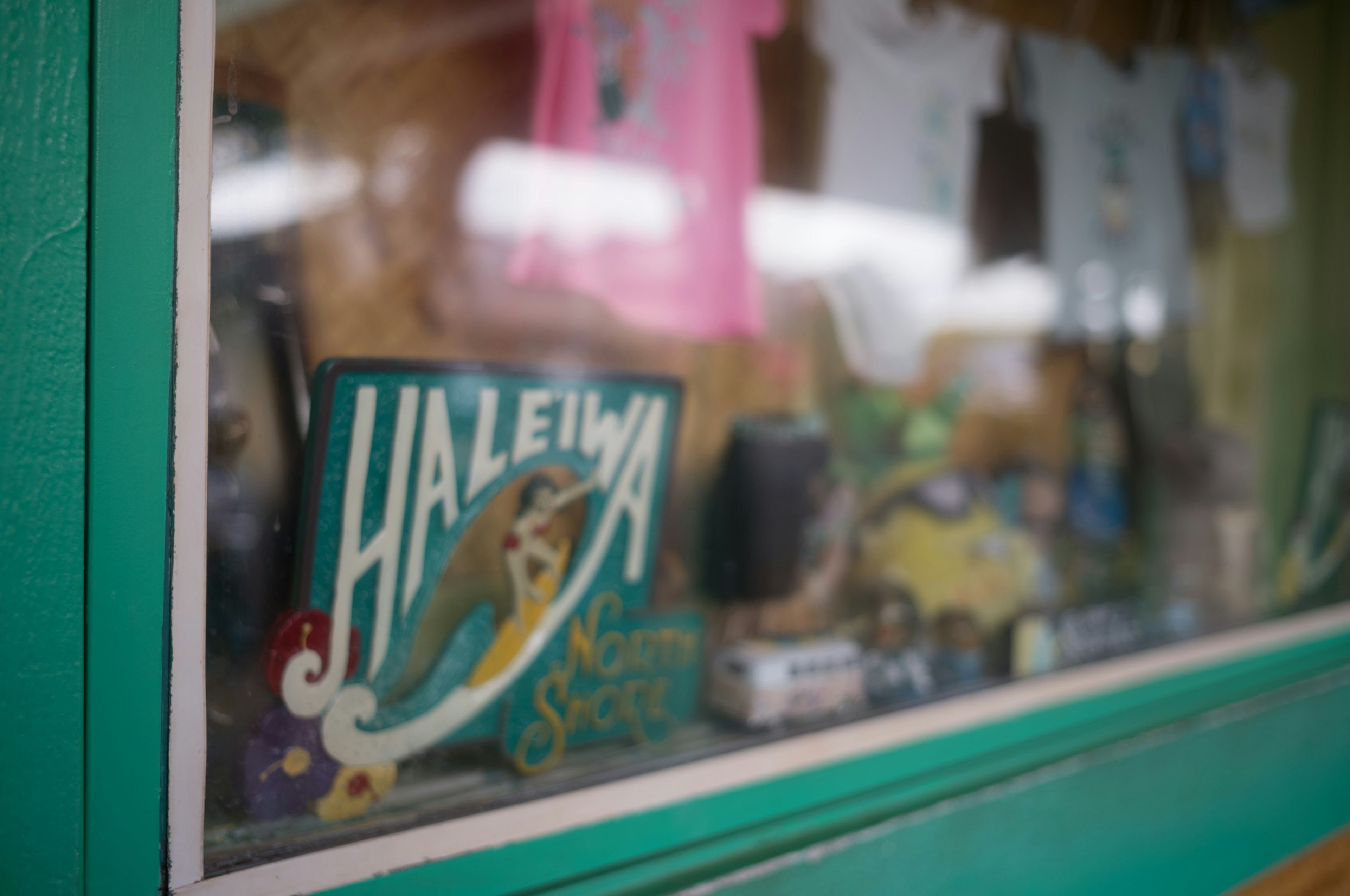 Display window of a souvenir shop featuring a Haleiwa sign