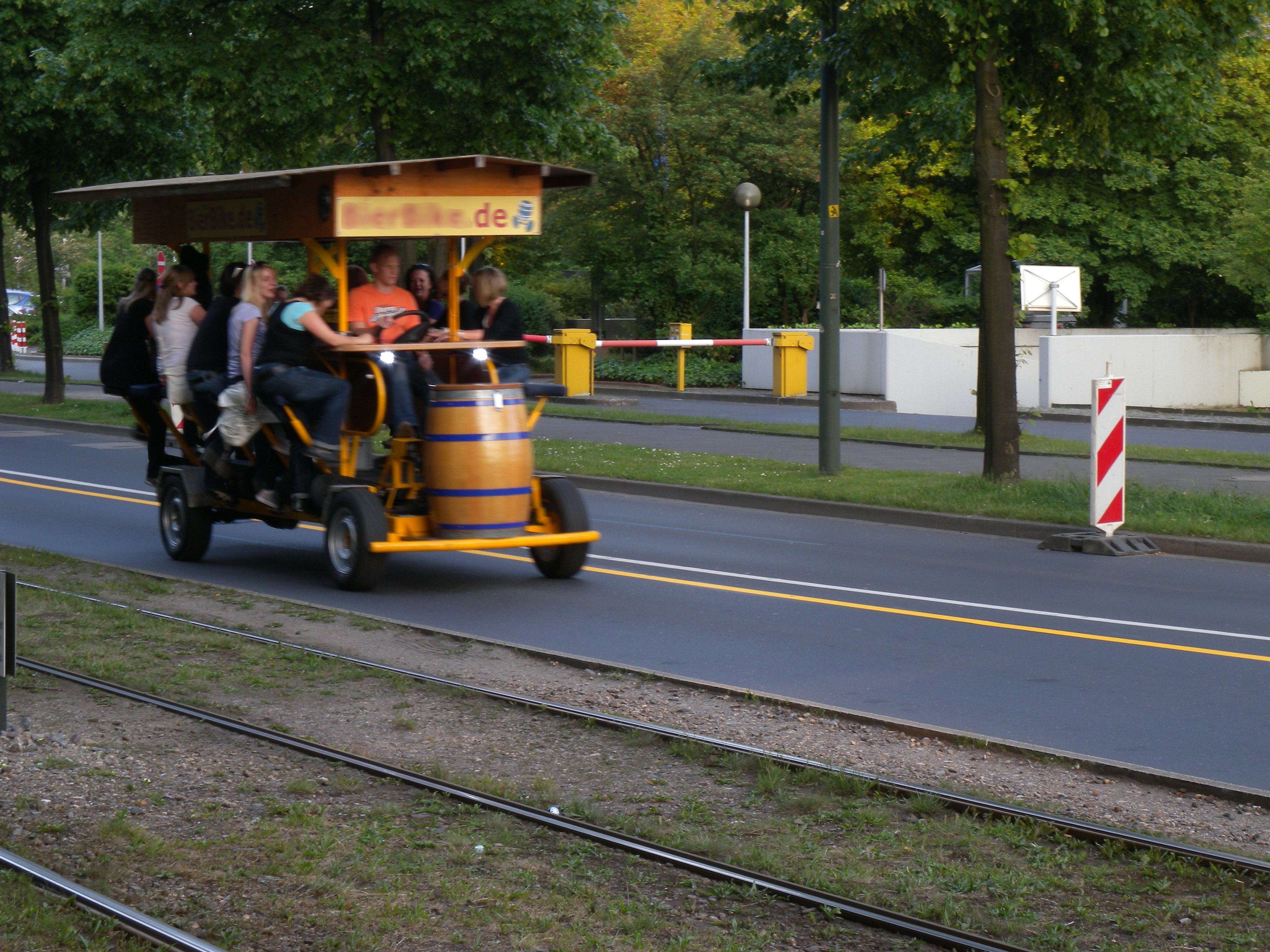 Group of people enjoying a pedal-powered vehicle on a street