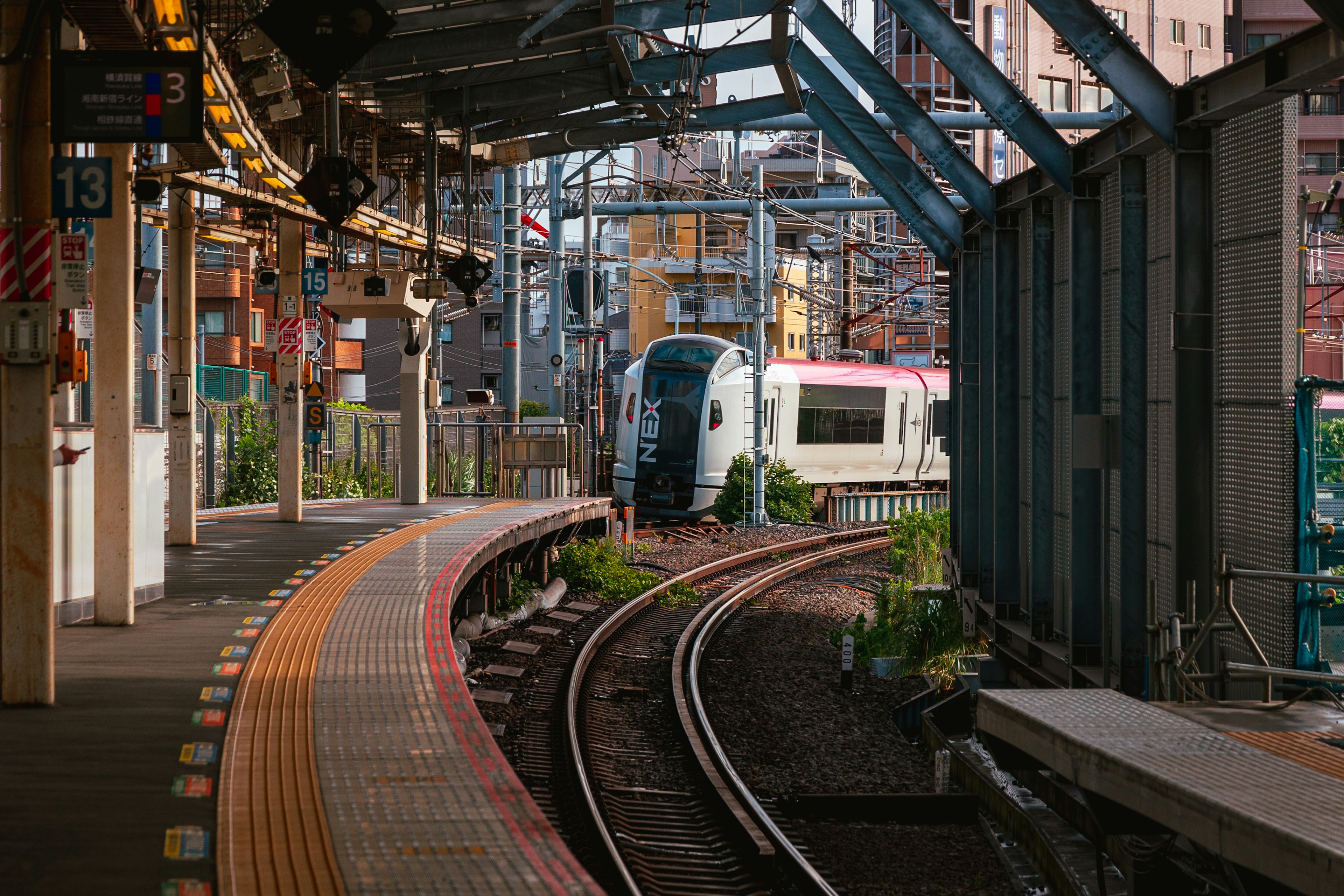 Train on the platform with curved tracks at a station