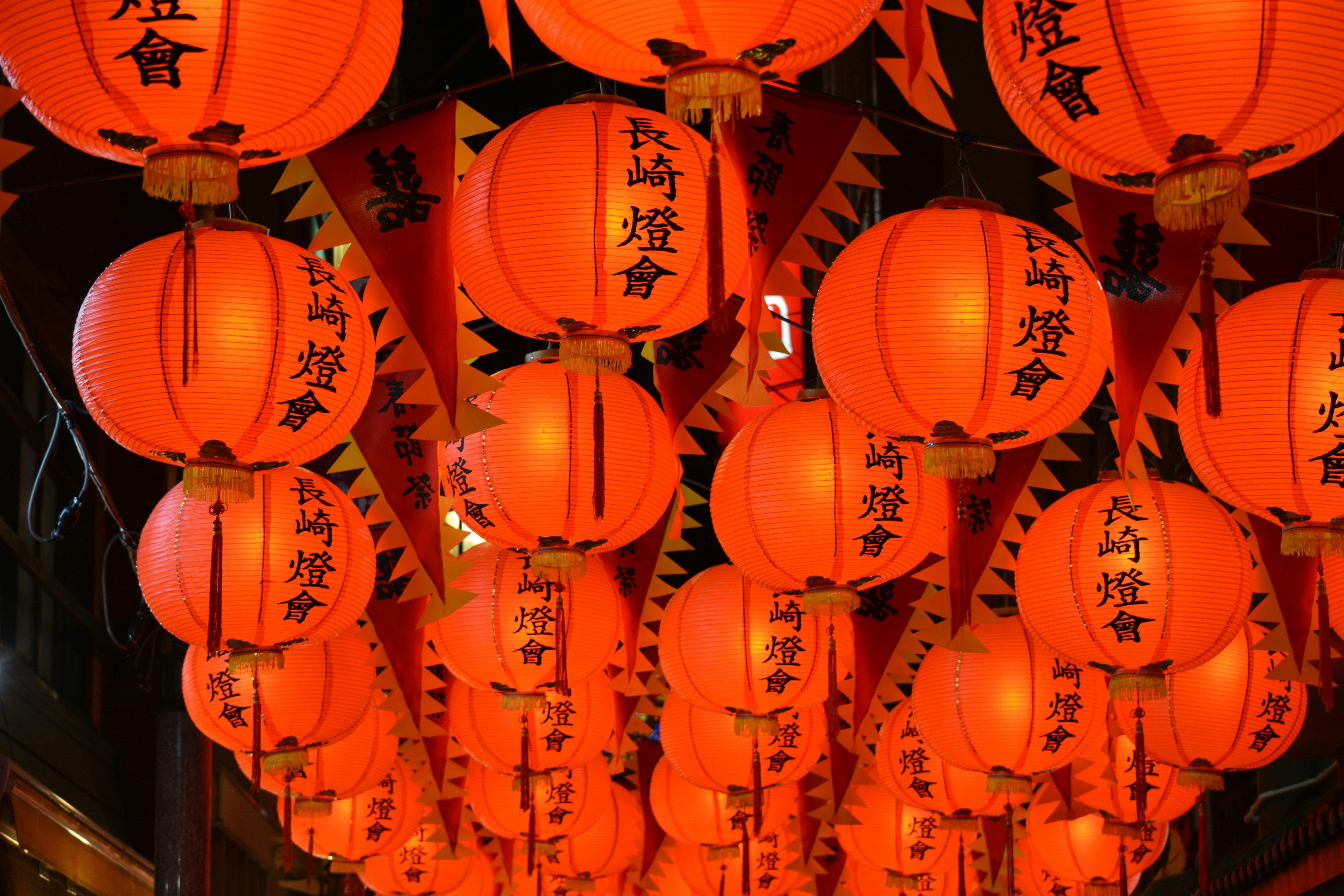 A vibrant display of red lanterns hanging in the night