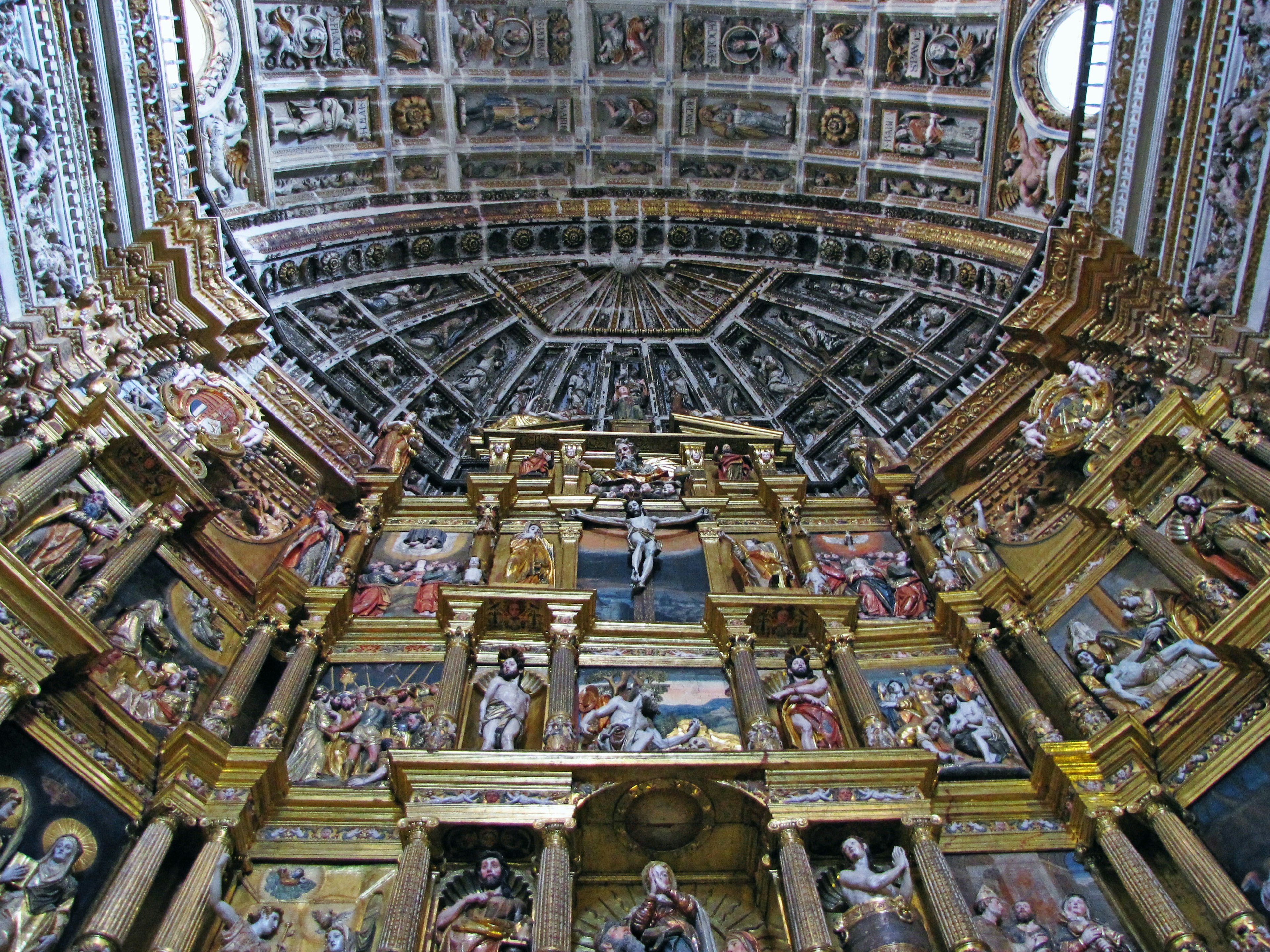 Ornately decorated church ceiling with intricate wall paintings