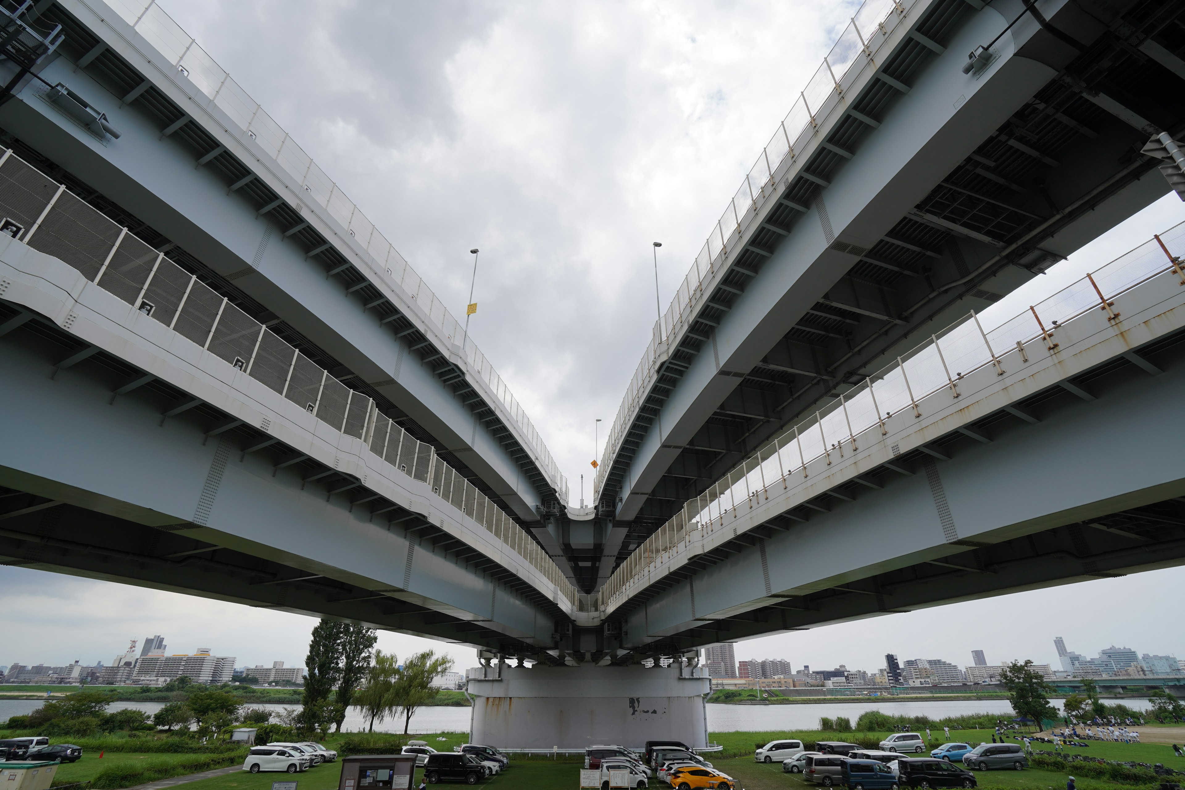 View from underneath a complex highway bridge over a river