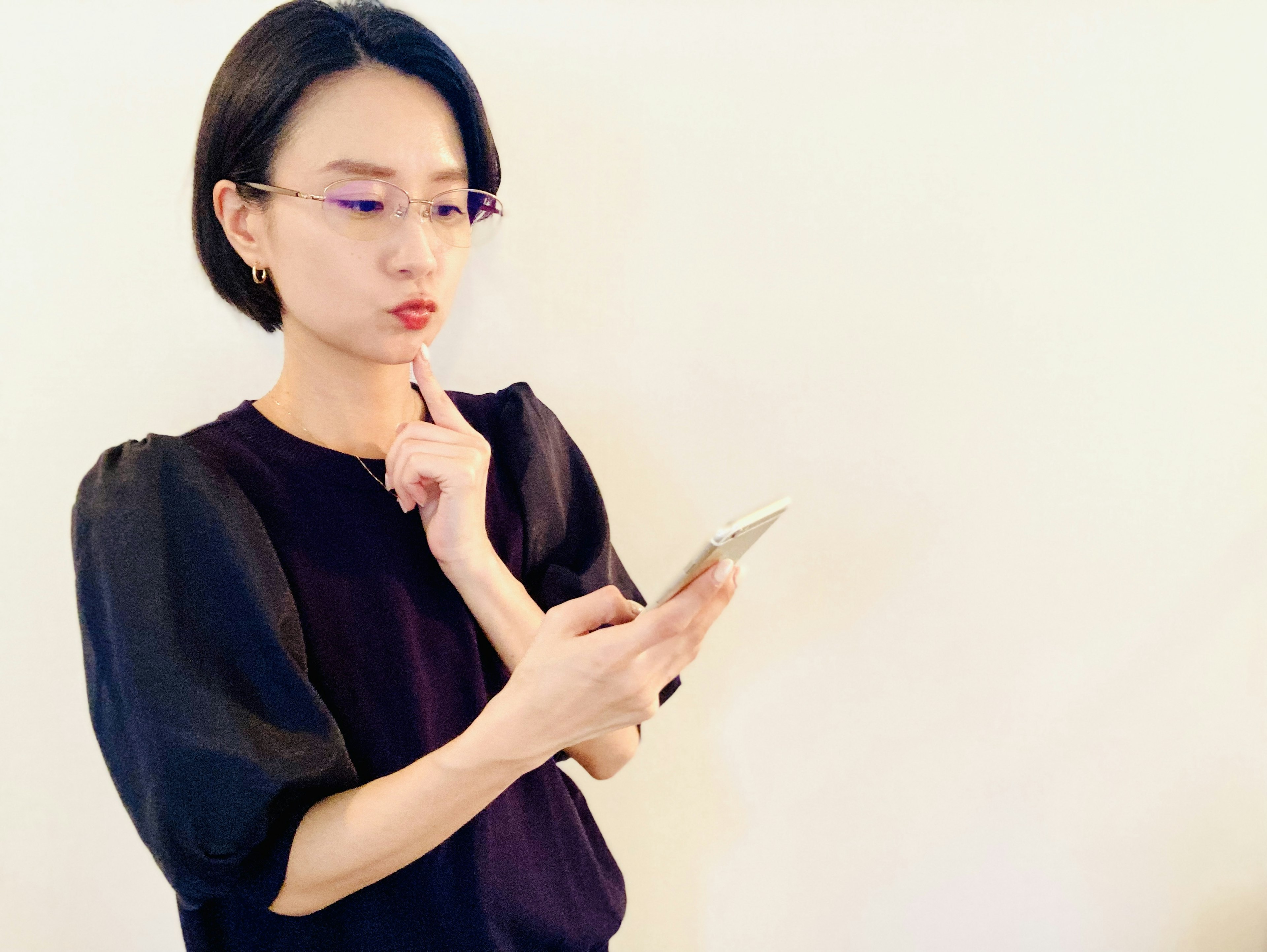 Portrait of a woman contemplating while looking at a smartphone