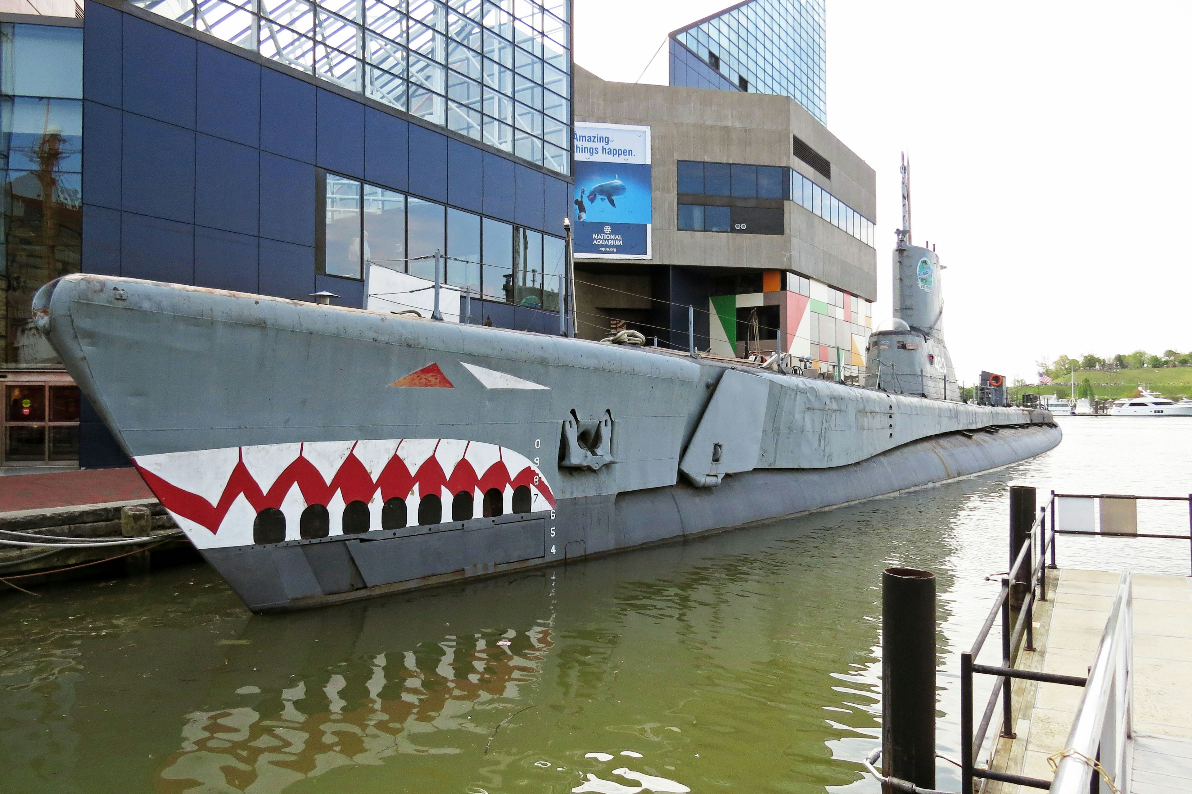 Sous-marin avec un design de requin amarré près de bâtiments modernes