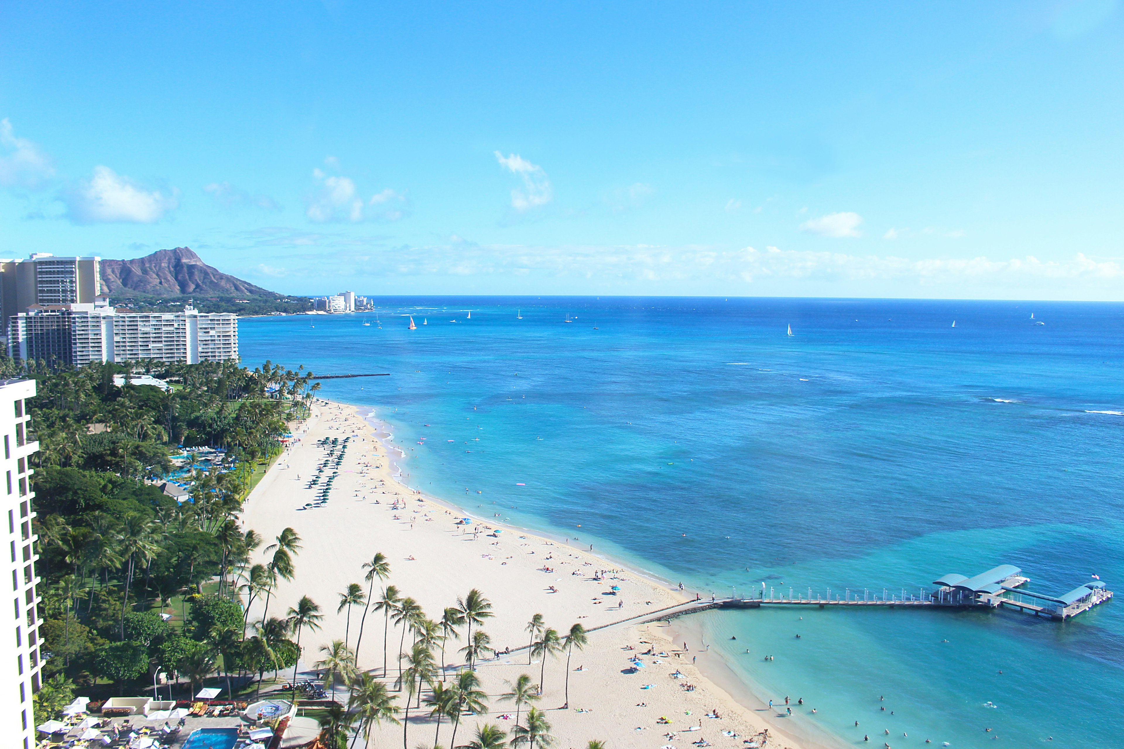 Vista panorámica de una playa hawaiana con océano azul y arena blanca