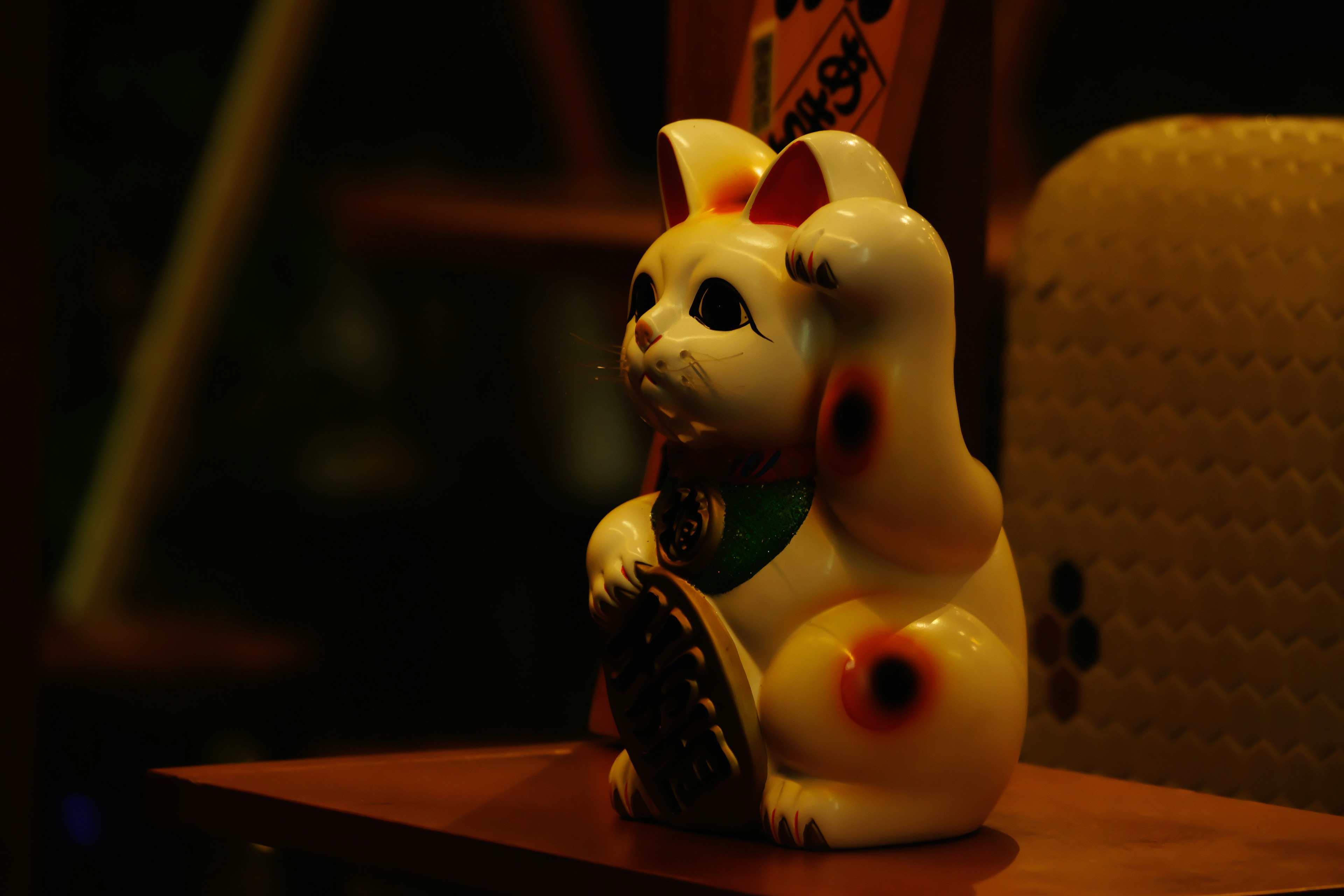 Ceramic lucky cat figurine in a sitting position