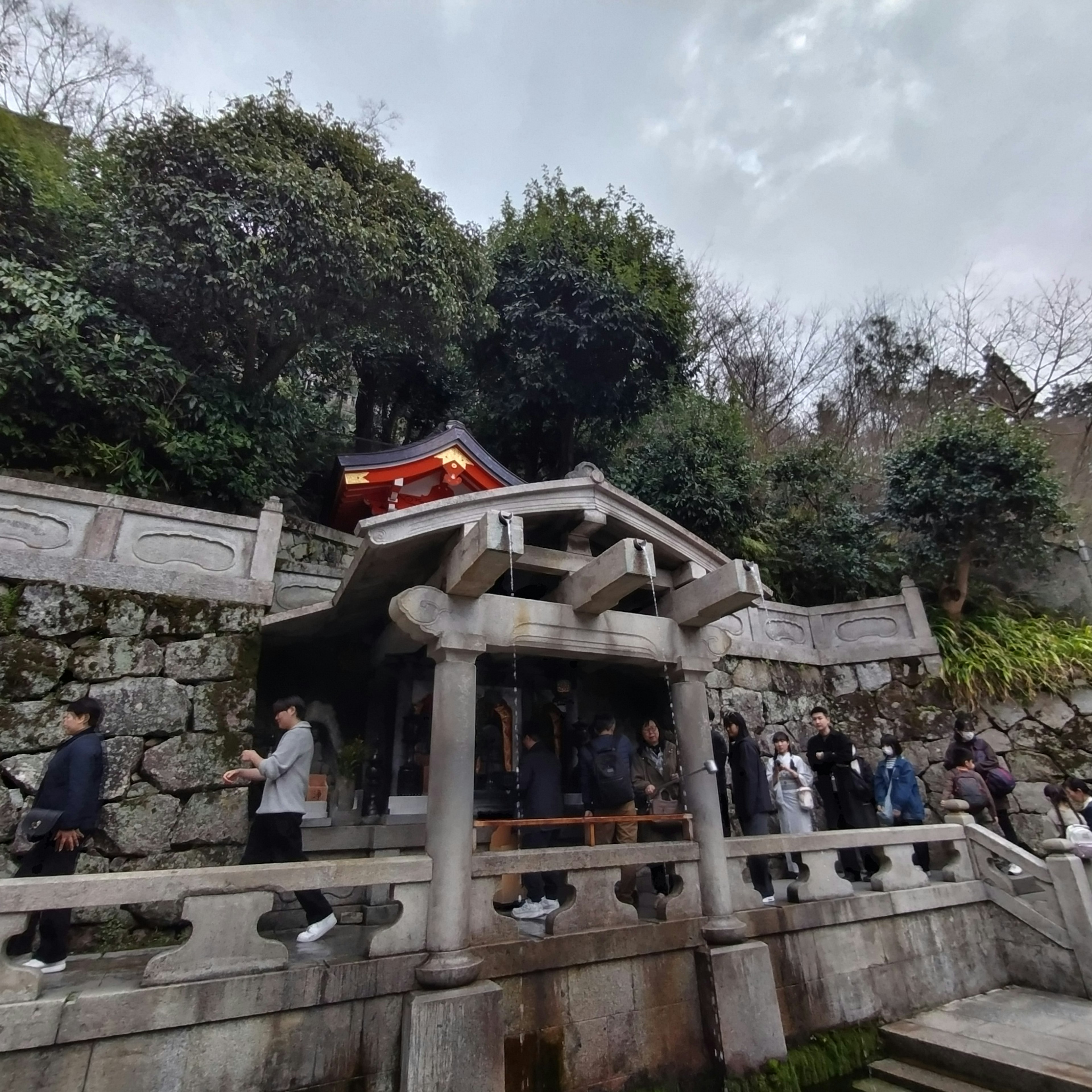 A shrine building in the mountains with visitors