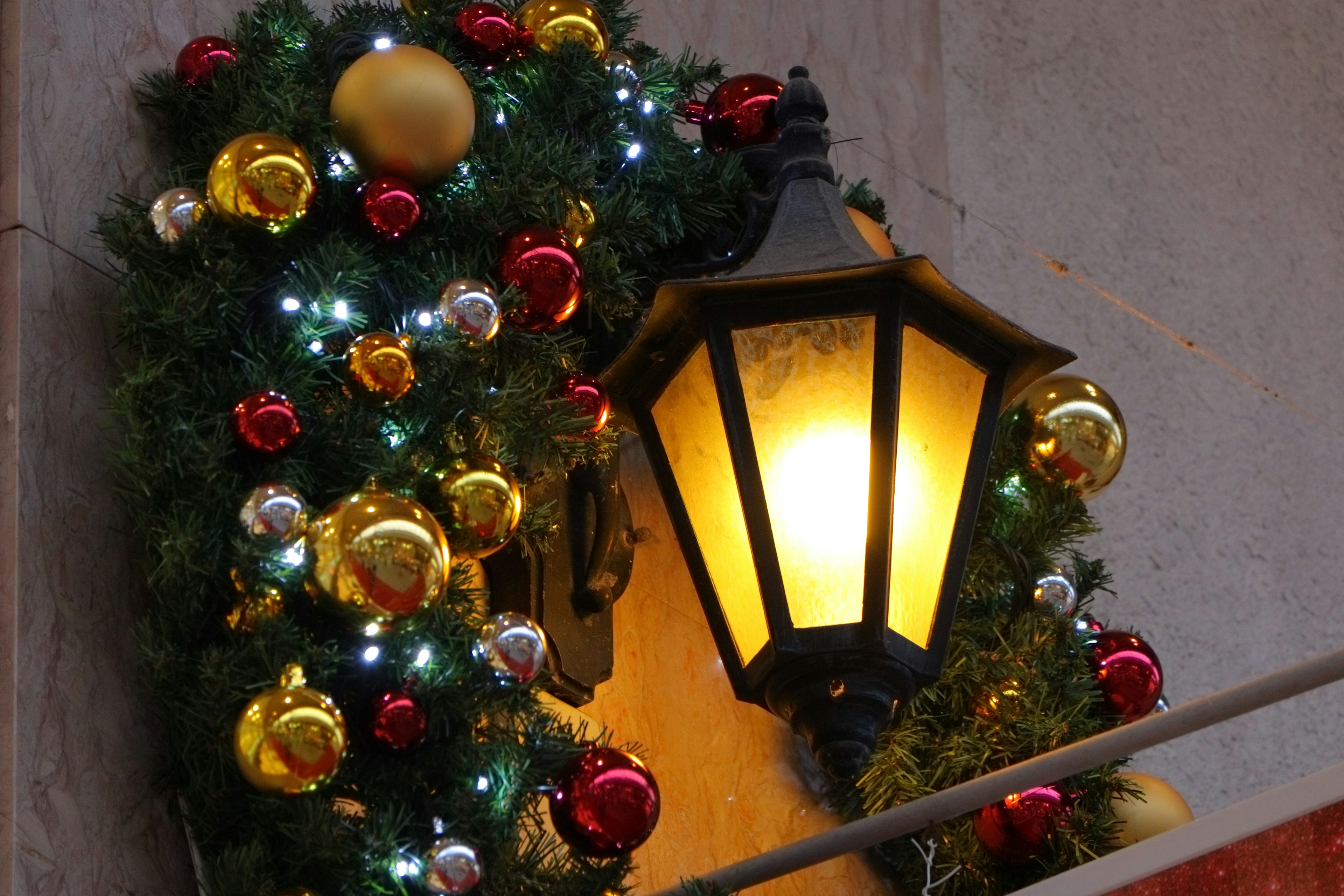 A street lamp decorated with Christmas ornaments and lights