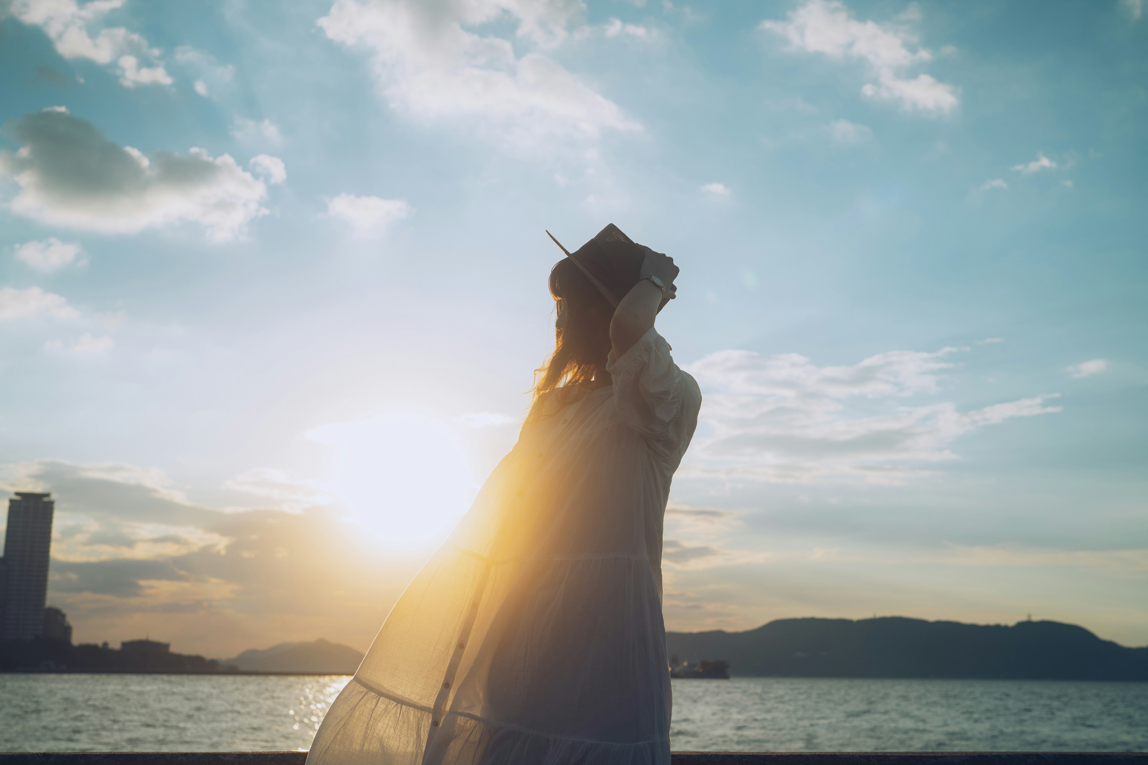 Silhouette of a woman against a sunset background