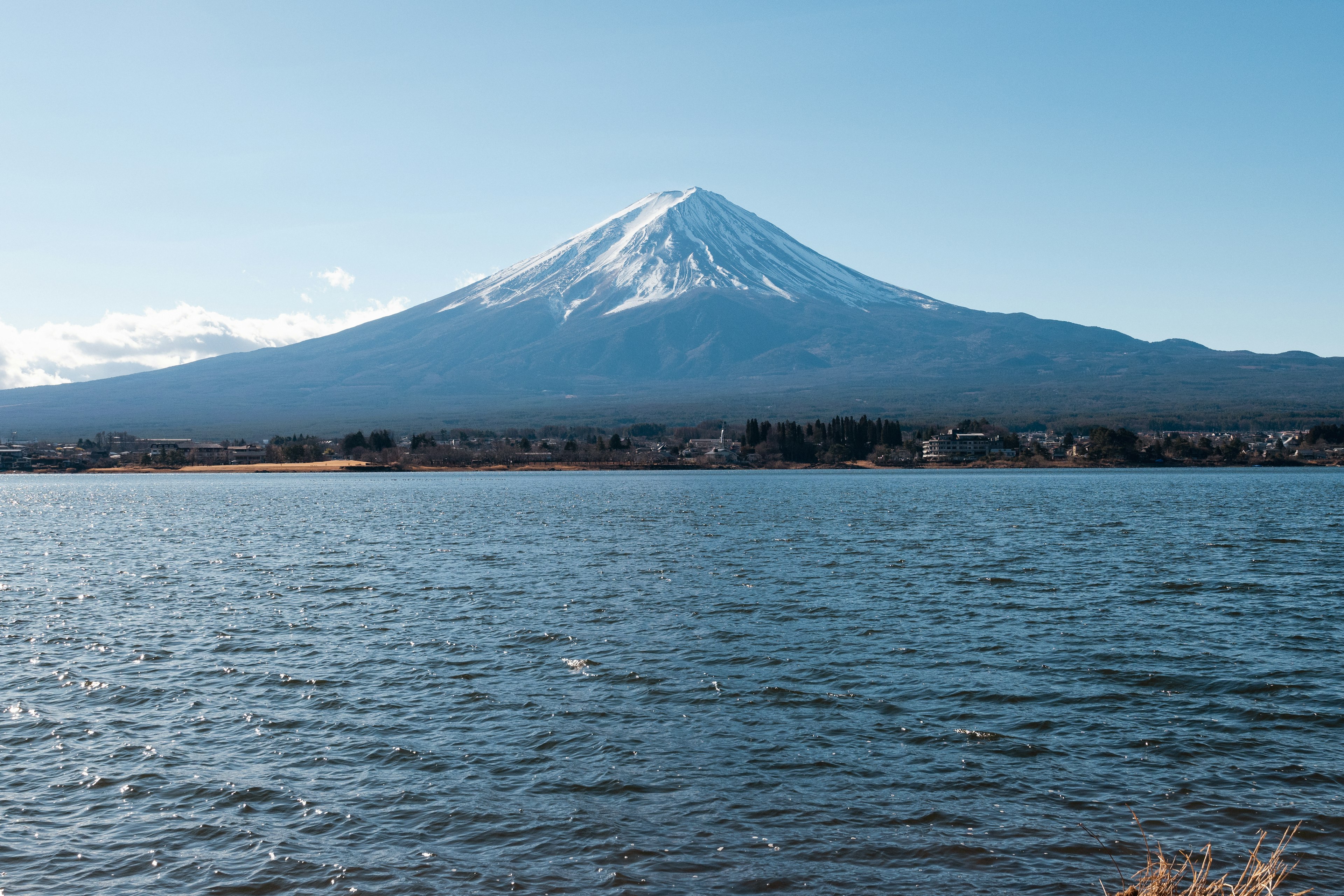 Beautiful view of Mount Fuji covered in snow near a lake