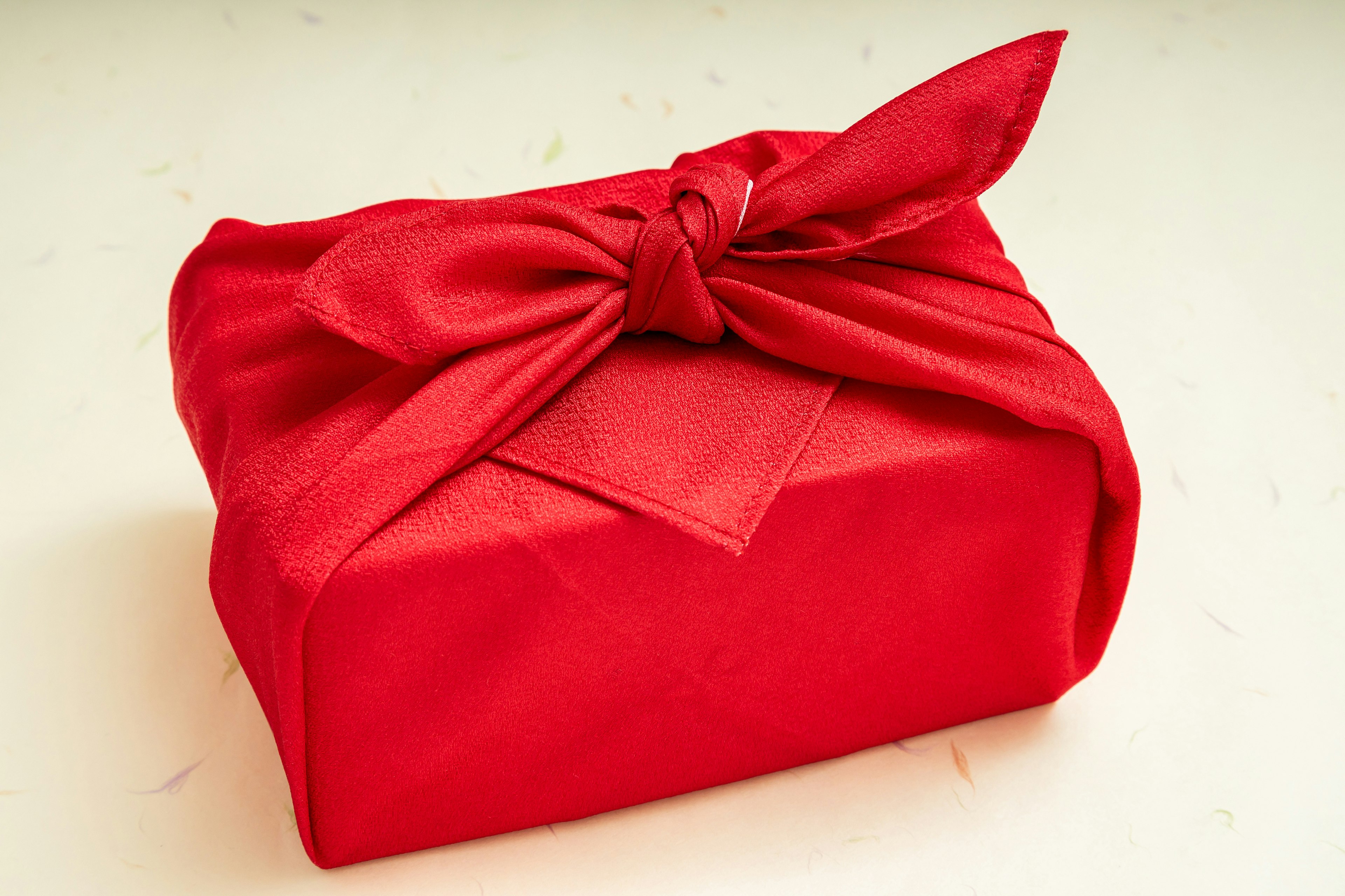 A gift box wrapped in red fabric