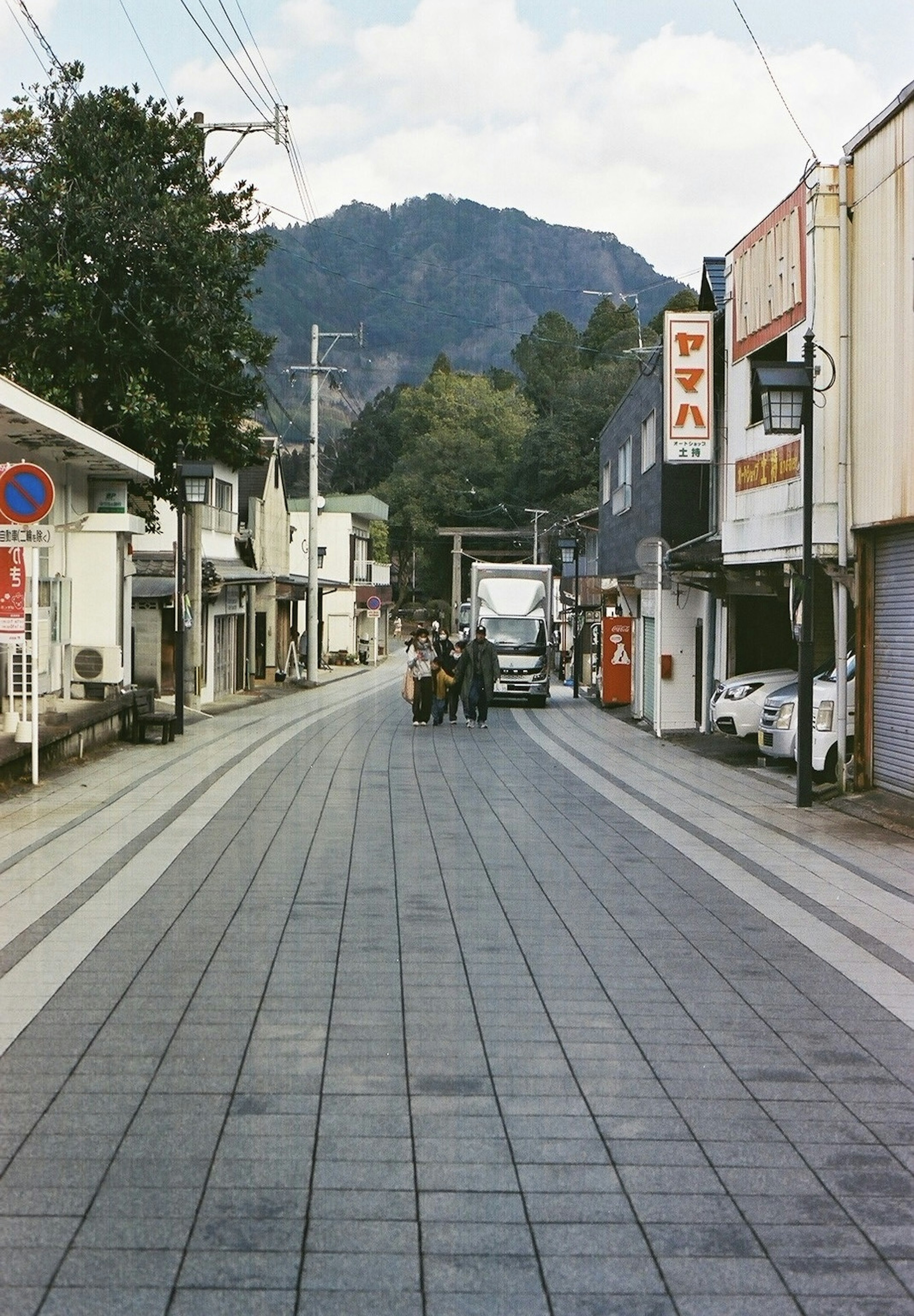 Quiet street scene with buildings and mountains in the background