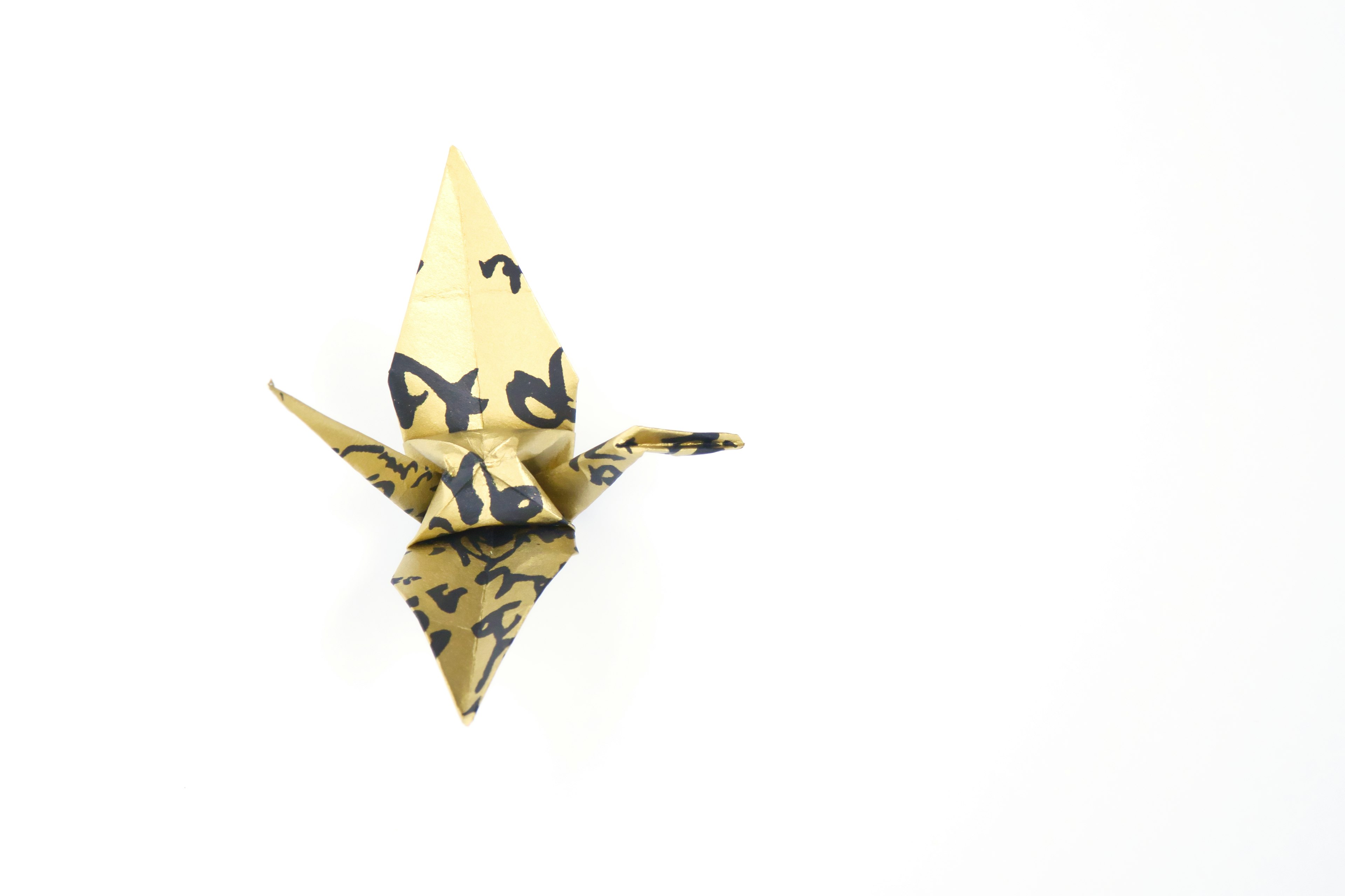 Origami crane placed against a white background