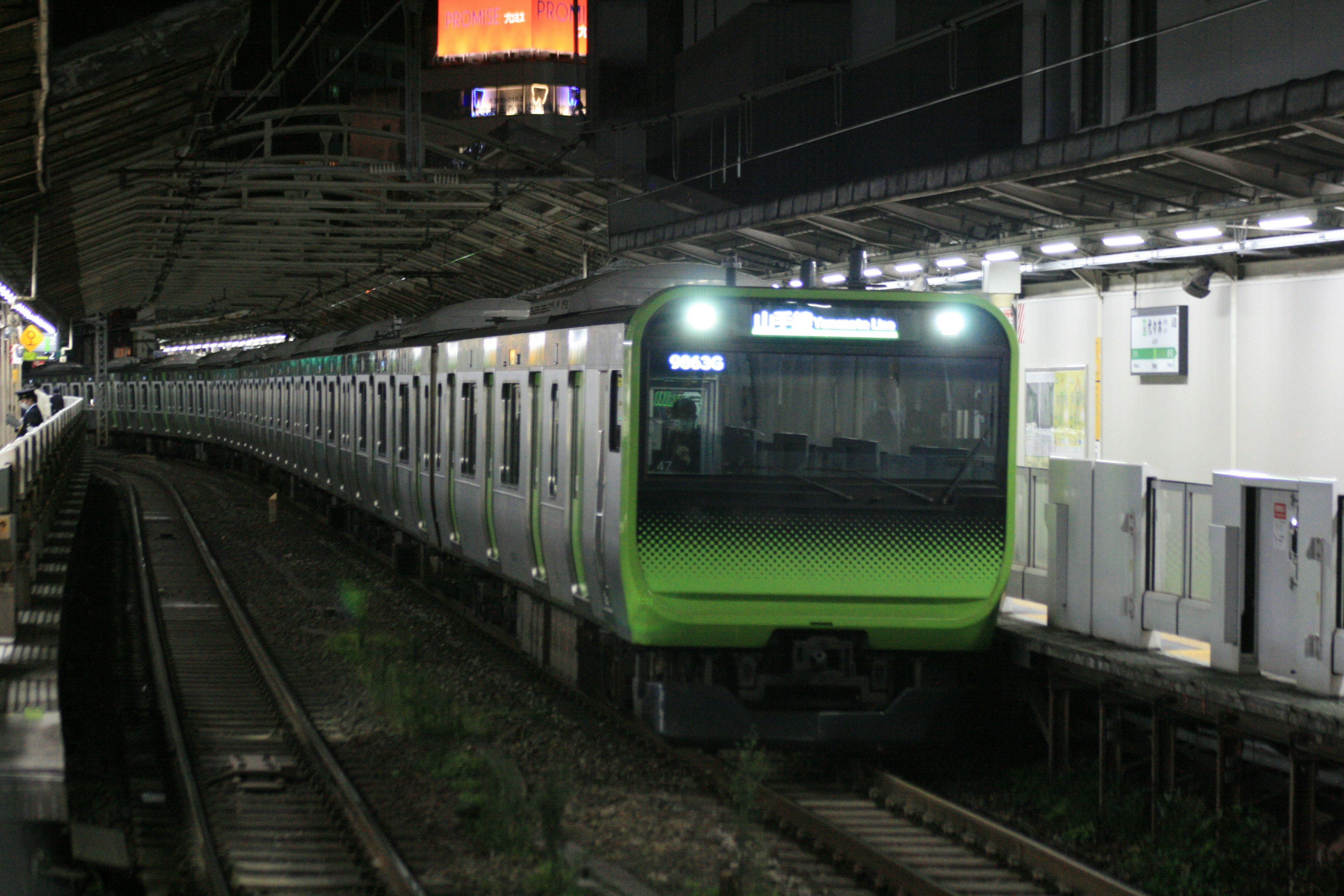 Green train at a nighttime station