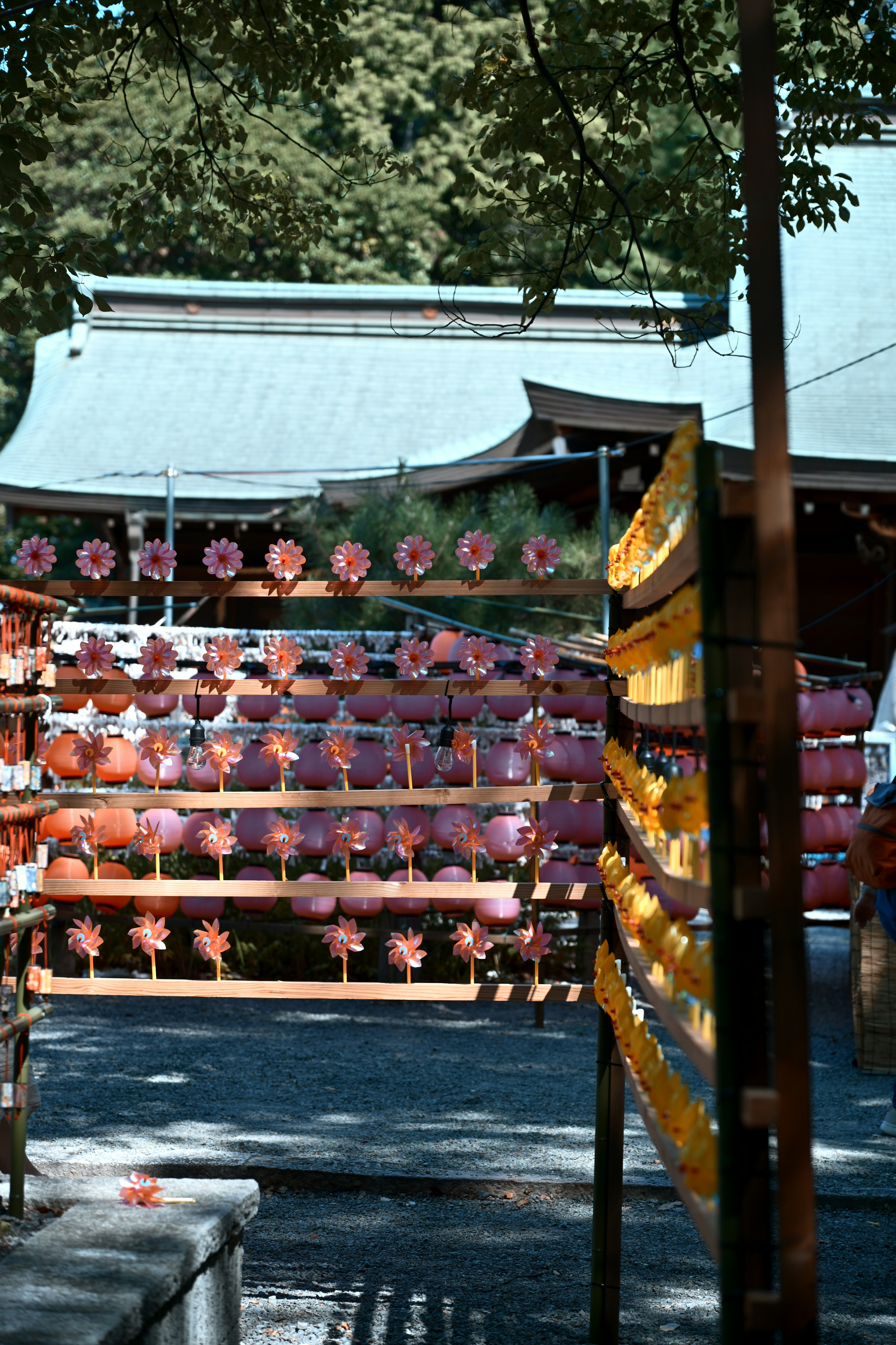 A serene shrine scene with colorful lanterns arranged