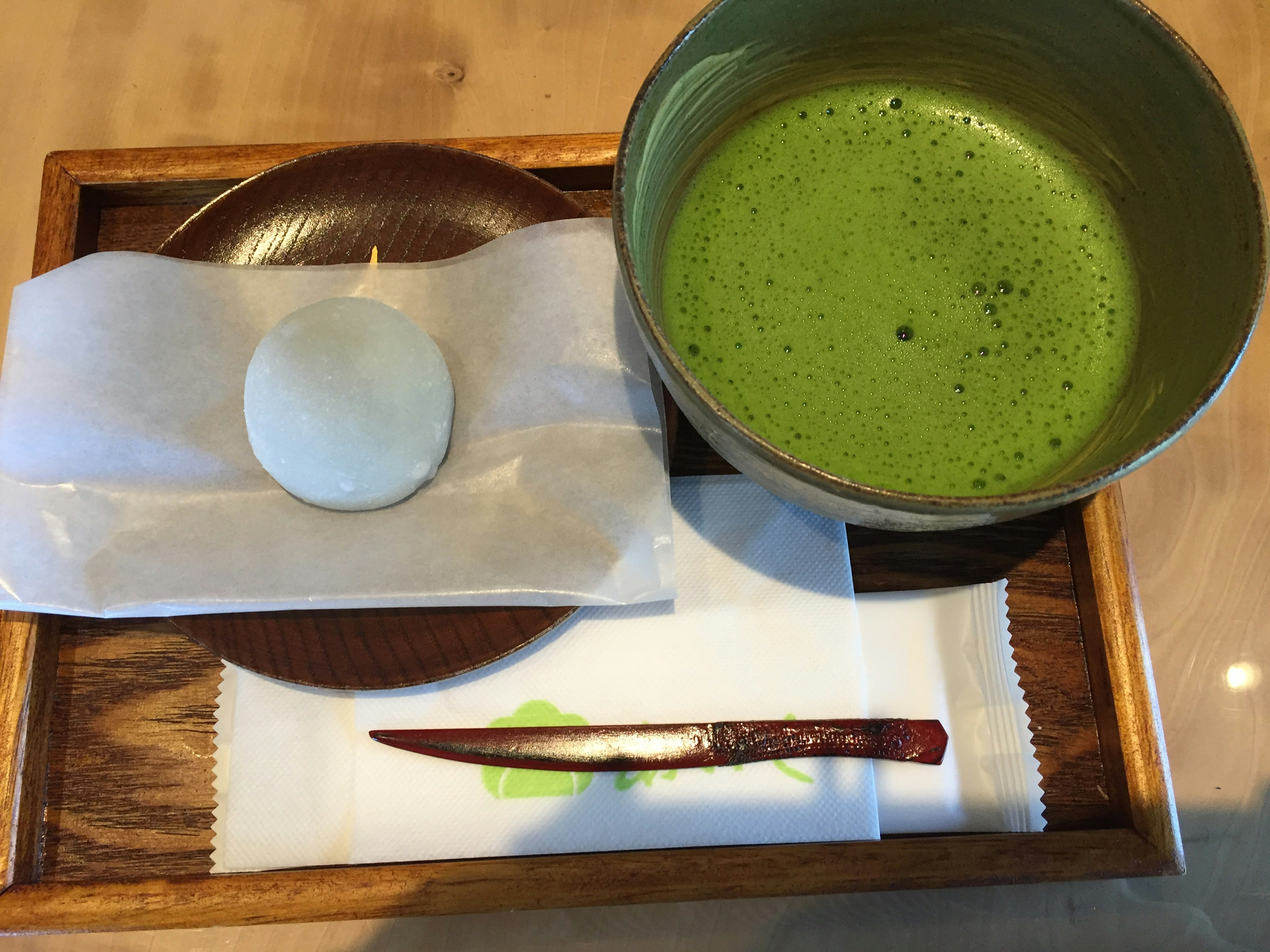 Matcha and wagashi set placed on a wooden tray