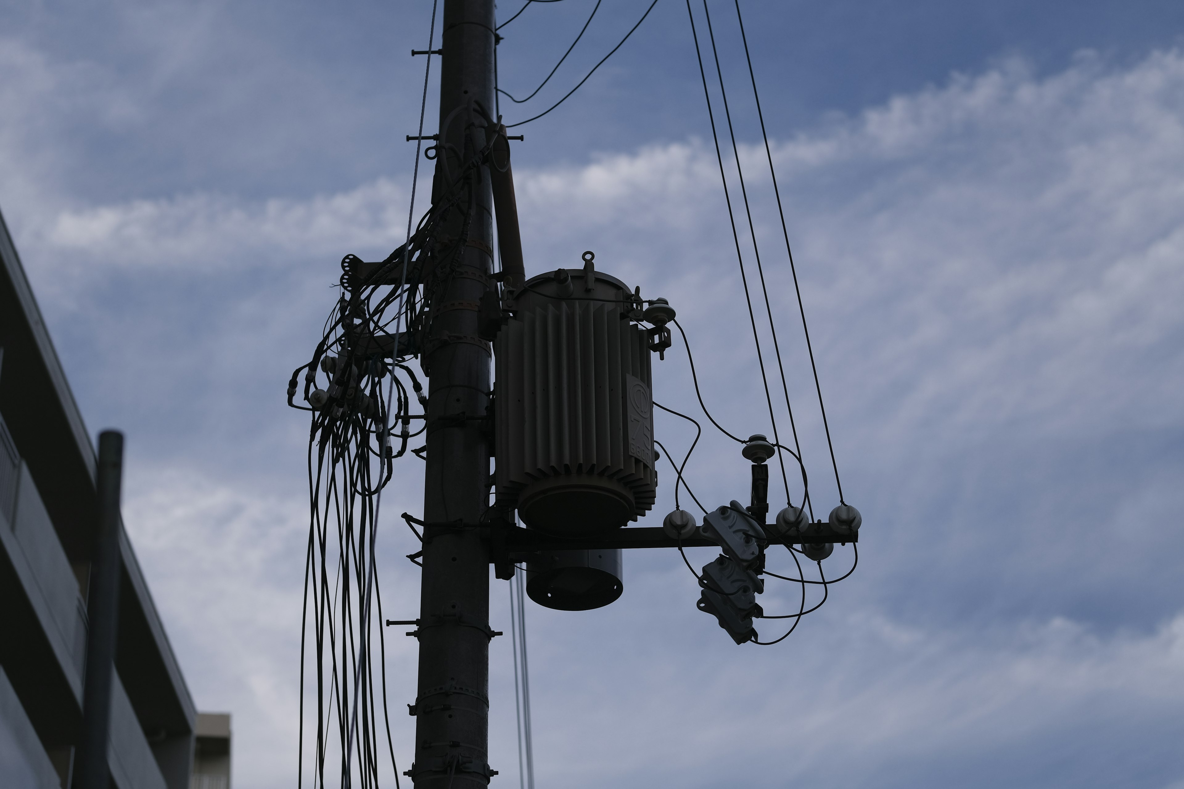 Power pole with transformer and electrical wires