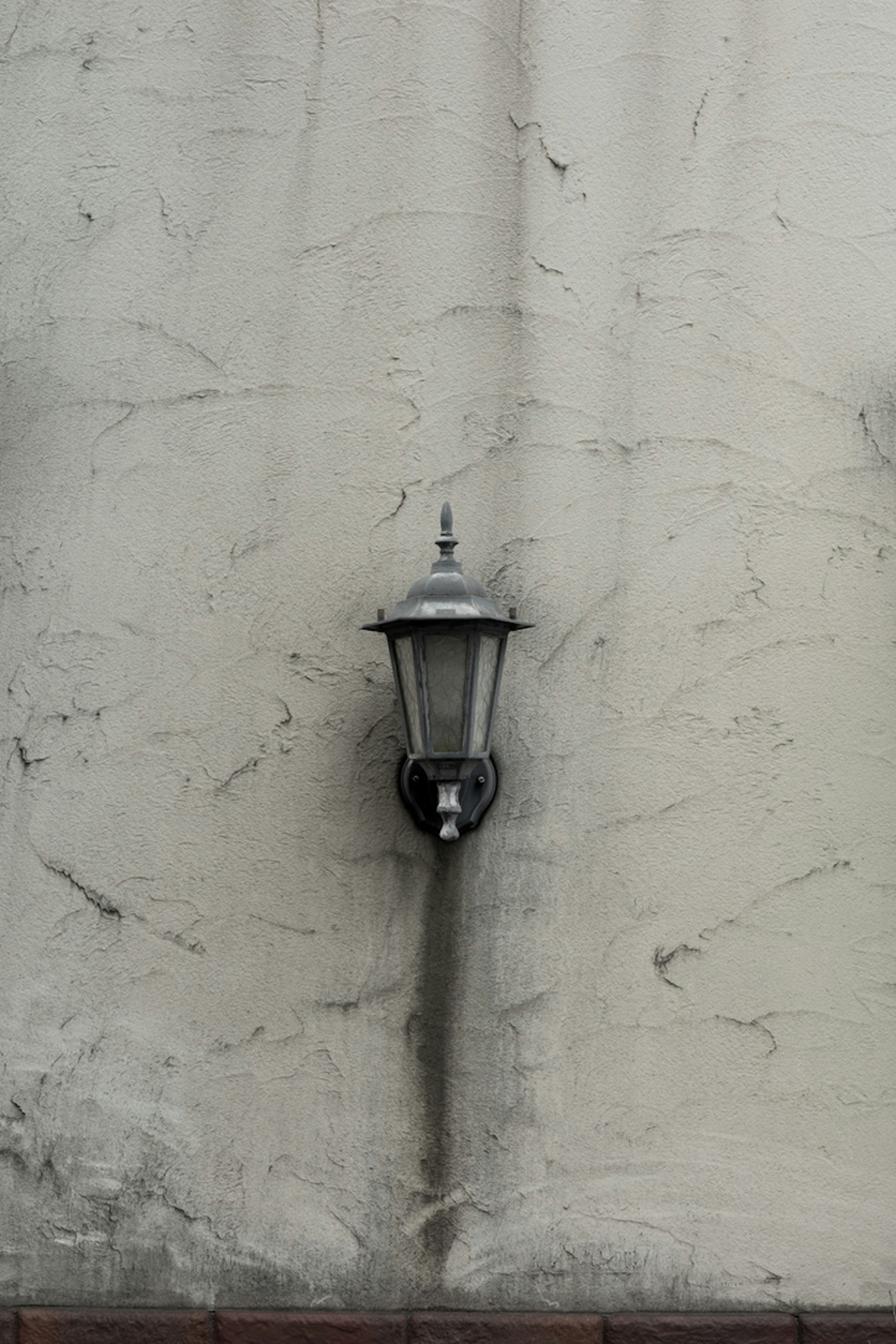 Classic lamp mounted on a textured wall