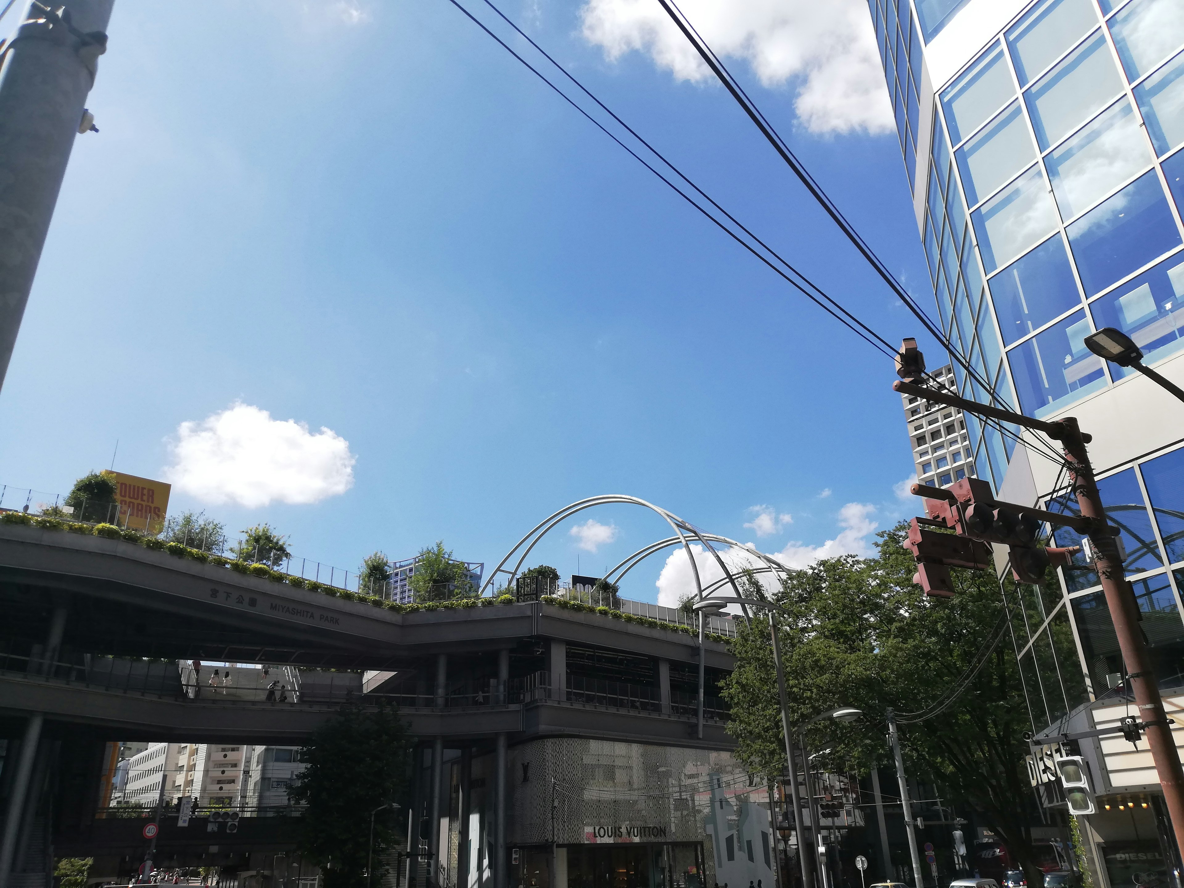 Urban landscape with modern buildings and green rooftops under blue sky