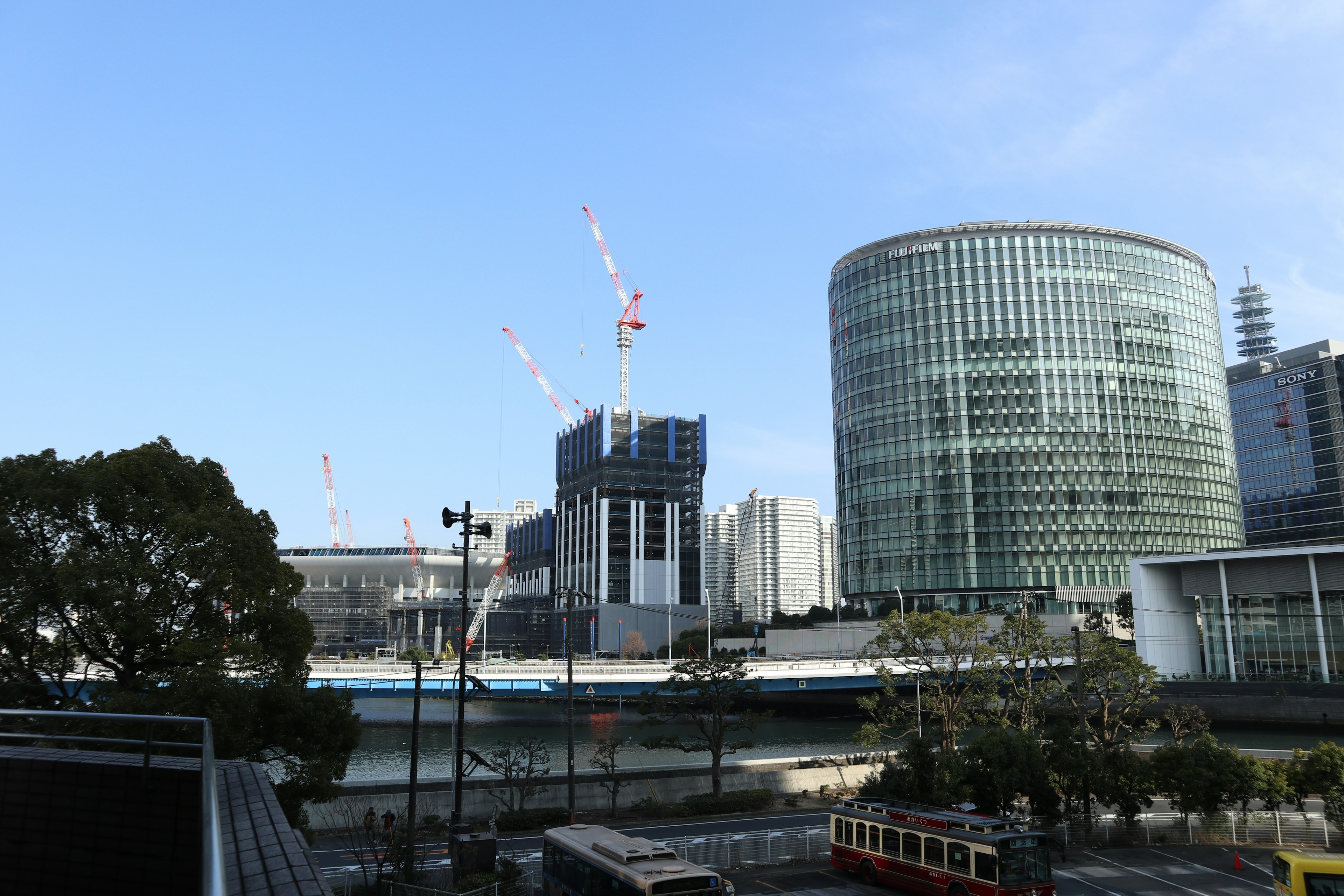 Urban landscape featuring modern buildings and construction cranes