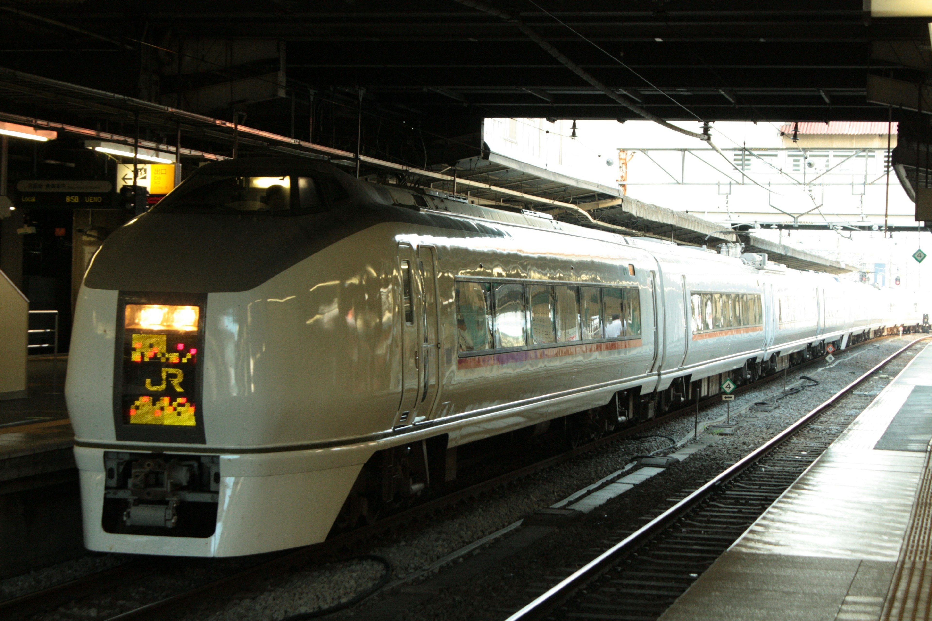 白い電車が駅で停車中の様子