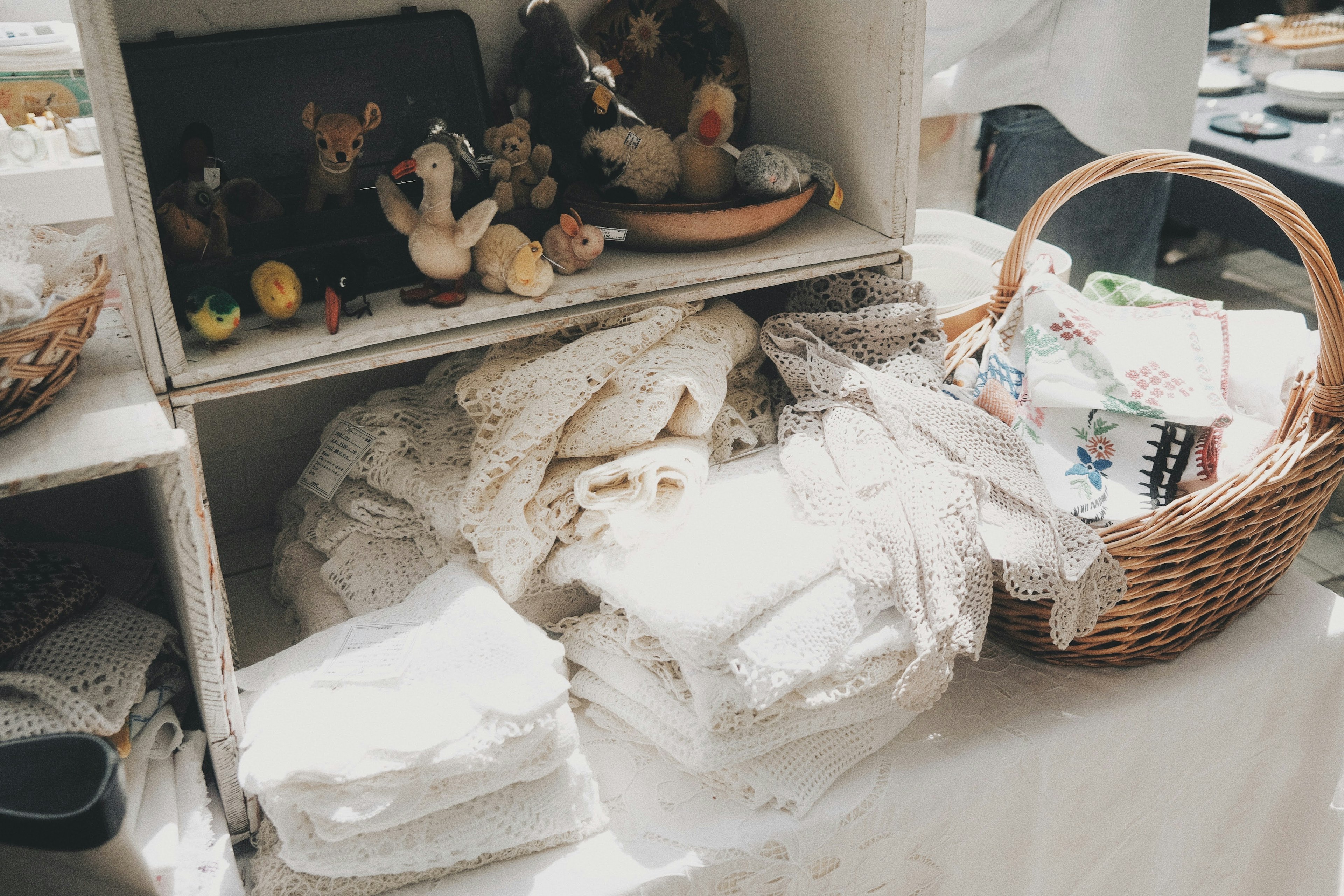 Market scene with white linens and plush toys on display