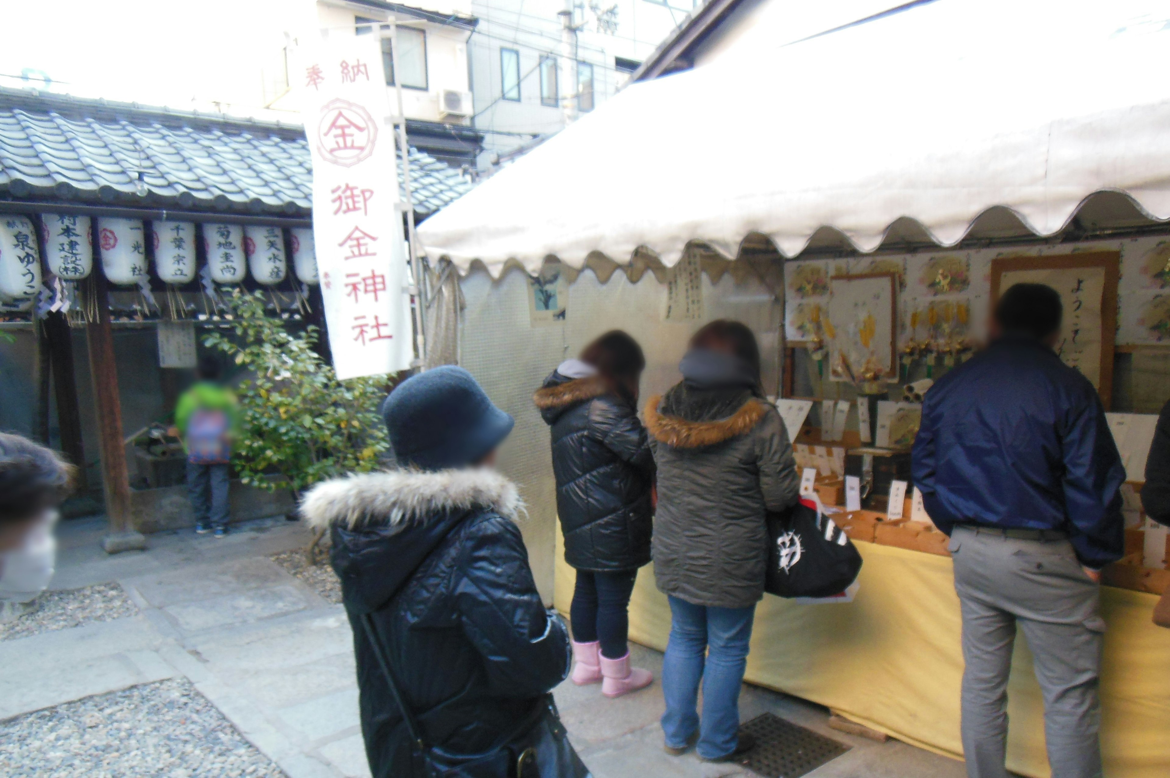 People waiting in front of a stall with traditional decorations